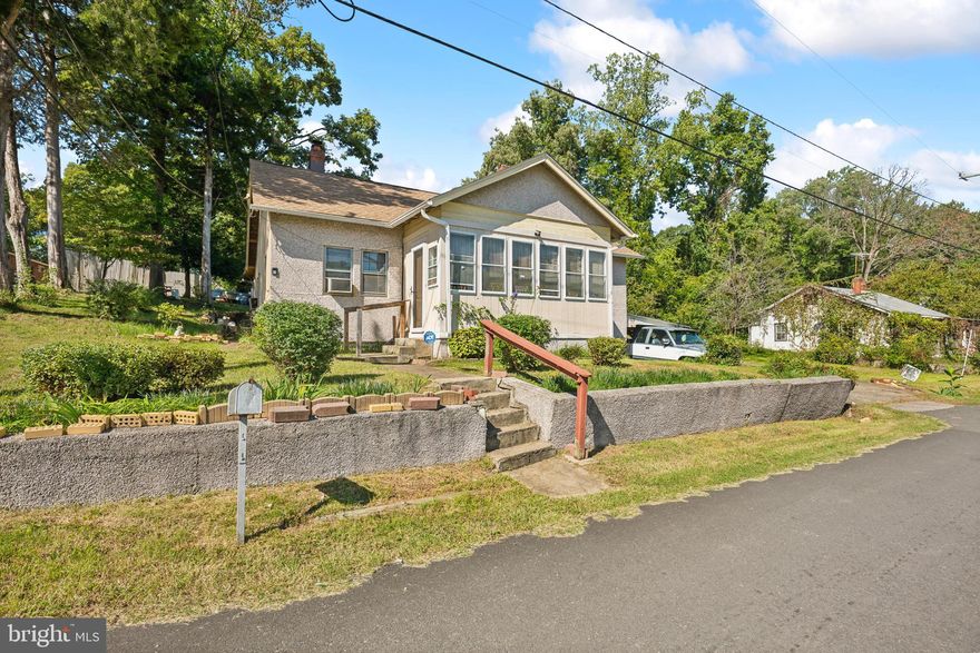 Investment opportunity in a prime location! This charming 1938-built fixer-upper has withstood the test of time and offers great potential. The home features 3 bedrooms, 1 full bath, a cozy fireplace, and a walk-up attic, spread across 1,376 sq ft of living space. The property includes a corner Lot 37 with a carport, though the driveway on Lot 35 is not included. Zoned R4 residential and currently occupied, this home is being sold strictly "as is." Don't miss out on the chance to restore this gem to its full glory!