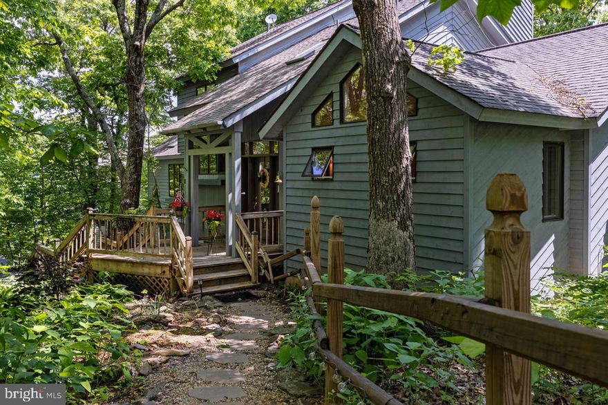 OPEN HOUSE 6/18 CANCELLED. RECEIVED OFFER AND RATIFIED THE CONTRACT.  Welcome to your dream home at Wintergreen Resort, where life is beautiful all year round! This stunning four-bedroom, three-and-a-half-bathroom home boasts a two-car garage, a workshop room, and a wine cellar, offering the perfect balance of comfort and luxury.

As you step into the grand living space, you'll be welcomed by cathedral ceilings, skylights, wooden beams and hardwood flooring throughout. The open concept kitchen features a Viking gas cooktop, two wall ovens, and a wood-burning stove, perfect for those cold winter nights. The living room has a masonry stone massive gas-converted fireplace, cradled by grand spacious living space (could be changed back to woodburning)  making it an entertainer's dream. There are 2 mini splits for cooling  & heating installed.

The home is located on the 12th  fairway (east - morning sunrise) with beautiful mountain views (west - sunset views during the winter) that will take your breath away as you step out onto your huge deck.  Relax on your deck (prepped for gas cooking/gas firepit/sink with water hookup),  soaking up the sun, taking in the views and watching the sunrise while enjoying your morning coffee.

This property is perfect as a vacation home or for permanent living in your four-season resort. You will have access to golfing, skiing, tennis, pickleball, hiking, dining, and so much more. You will also love the cooler temperatures during summer.

The first-floor primary suite is equipped with a walk-in shower, providing privacy and comfort. The bottom floor with outside access,  provides another optional suite featuring a soaking tub.  Upstairs, you will be pleased to find a loft overlooking the great room and 2 gracious-sized bedrooms interlocking a jack & jill bathroom.  Plenty of parking is available with level,  paved driveway (easily accesible for your guests) and 2 car garage for inclimate weather conditions.

Overall, this home is a rare find, offering luxury, comfort, and breathtaking mountain views. Don't miss the chance to make this magnificent property your own - schedule a tour today!