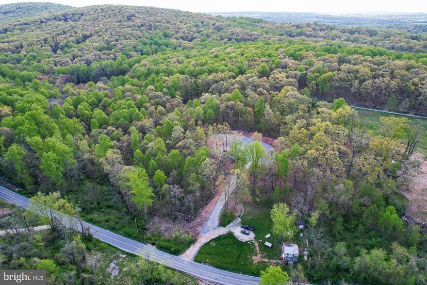 Would you like to have some breathing room and privacy, yet be near stores and schools? This 3.8 acre building lot ready for your dream home! The seller has already cleared, leveled, and stoned a large area to build on, so you won't have that headache and expense. This location is just perfect. It feels like you're out in the country, but it's just a few minutes into town for convenience. The seller has tied pink ribbons on some trees to give you an estimate of the lot lines. Loads of room for a garden, or a pole building, or pets, or for kids to roam. (Or to keep other people's pets and kids away. ;) The small trailer will be removed prior to settlement. How do you envision your paradise?