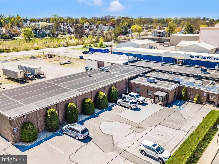 Exceptional commercial real estate opportunity that offers both functionality and flexibility for a variety of business uses. Located on a level 3.98-acre parcel with dual street access from W Lee Street and Sycamore Street, this modern, one-story brick office building with an attached block warehouse totals approximately 16,592 square feet and sits on 3.98 flat acres. The property is zoned IR (Industrial Restrictive) and benefits from dual street access.

The office portion of the building includes 5,641 square feet of finished space, featuring a main reception area, conference room, executive offices, media center, kitchenette, multiple restrooms, and other supporting areas and storage. The space is climate controlled with zoned heating, central air conditioning, four rooftop HVAC units, two split systems, and a gas hot water boiler.
The warehouse portion of the building is approximately 10,950 square feet and features a concrete slab foundation, nine overhead doors, and a 14-foot ceiling height. The original section has a gable metal roof, while the addition has a rubber membrane roof. Inside the warehouse, there is a separate office, a heated and cooled bathroom facility, a welding shop with suspended heaters, and additional areas designated for pipe storage or general workspace.
The property also features chain-link perimeter fencing, asphalt parking, and strategically placed driveway entrances from both adjacent streets. Excellent combination of office comfort and warehouse utility in a flexible, industrial-zoned setting. Its layout and features make it ideal for contractors, distribution, light manufacturing, or service-based operations.

 Another key advantage of this property is that it includes three different front entrances, making it suitable for multiple businesses or potential tenant setups. Whether for an owner-user looking to occupy and lease additional space or an investor seeking rental income, this property provides a solid foundation for future growth. This building offers tremendous value and potential.