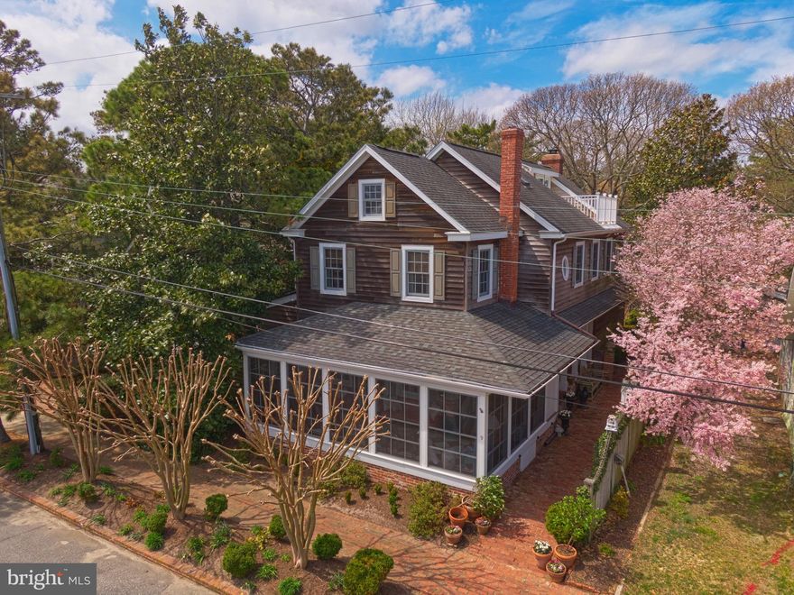 Unique, spacious and charming home in Rehoboth Beach just steps from the ocean.  This home has 7 bedrooms, 4 full baths, and 2 half baths in the main house with a guest house on the property with a living space, gas fireplace, kitchen, bedroom and full bath.  Inside the main house you will find tiger maple floors on the first floor, wide plank pine on the second floor.  There are two living rooms each with a wood burning fireplace, updated kitchen with large dining area, 1st floor master suite with fireplace, separate laundry, walk-in closet, and two marble bathrooms.  On the second floor are 4 bedrooms, 2 full baths, and laundry.  The third floor boasts an office space, sitting area, bedroom and half bath, plus a balcony with ocean views.  The many decorative features include painted floors and walls.  There is a front porch with screens and plexiglass storms, brick rear patio, fully fenced back yard, and an outdoor shower.  This home also has a finished basement with pool table, workshop, and a 1500 bottle wine cellar.  This house could not be built under today's building code.