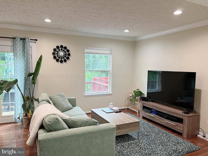 Welcome to your new home nestled in the serene Park Summit community, where you'll experience the perfect blend of comfort and nature's beauty. This remarkable end unit townhouse offers an unparalleled lifestyle with its proximity to 73 acres of pristine parkland. Upon entering, you'll immediately notice the updated luxurious vinyl flooring, fresh paint, and updated appliances. The main level of this home is bathed in natural light, with a sunny kitchen offering a quaint sitting area by the windows, making it the perfect spot to enjoy your morning coffee. The adjacent dining room and family room create an inviting space for gatherings. Sliding glass doors lead out to a spacious deck, an ideal setting for outdoor relaxation and entertainment. Moving to the upper level, you'll find a primary bedroom retreat that includes an updated ensuite bath and double closets. Down the hall are two additional spacious bedrooms and an updated full bath.  The lower level offers a fully finished walk-out basement, featuring a cozy fireplace, a spacious laundry and utility room, along with a convenient half bath. The Park Summit community offers an array of amenities, including tennis courts, a large community pool, and tot lots, ensuring endless entertainment options right at your doorstep. For outdoor enthusiasts, Malcolm King Park is just steps away and boasts a 2.1 mile hiker-biker trail, two tennis courts, a basketball court, multi-use field space, pickleball lines, picnic tables, a playground, a tot lot, and scenic trails. Convenience meets luxury living with easy walking access to Lifetime Fitness, Downtown Crown, and Rio, making this townhouse an ideal retreat for those seeking the perfect blend of nature and modern amenities.