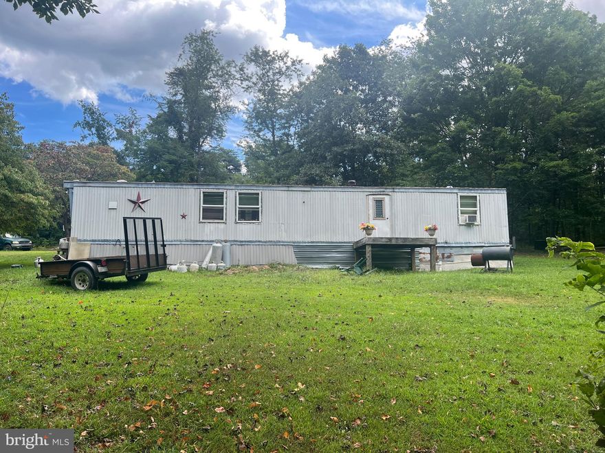 5.11 UNRESTRICTED acres located along WV-9 W/Cacapon Rd! This mostly wooded lot was cleared in just the right location for the home leaving the wooded acreage to the front, sides, and back of the property affording plenty of privacy while being located off a state-maintained road. The mobile home has had a few updates - kitchen cabinets, windows, and some of the flooring has been updated. There are 3 outbuildings on the property for all your storage needs. There are so many possibilities for this property - use the acreage for hunting and set up "camp" in the mobile home, remove the mobile home and build your dream home, or possibly improve upon what has already been started within the mobile home, use this as a rental, and build your dream home in a different location on the property. Whatever your idea for the property may be - it is definitely worth having a look! Schedule your showing today! Property is being sold strictly as is.