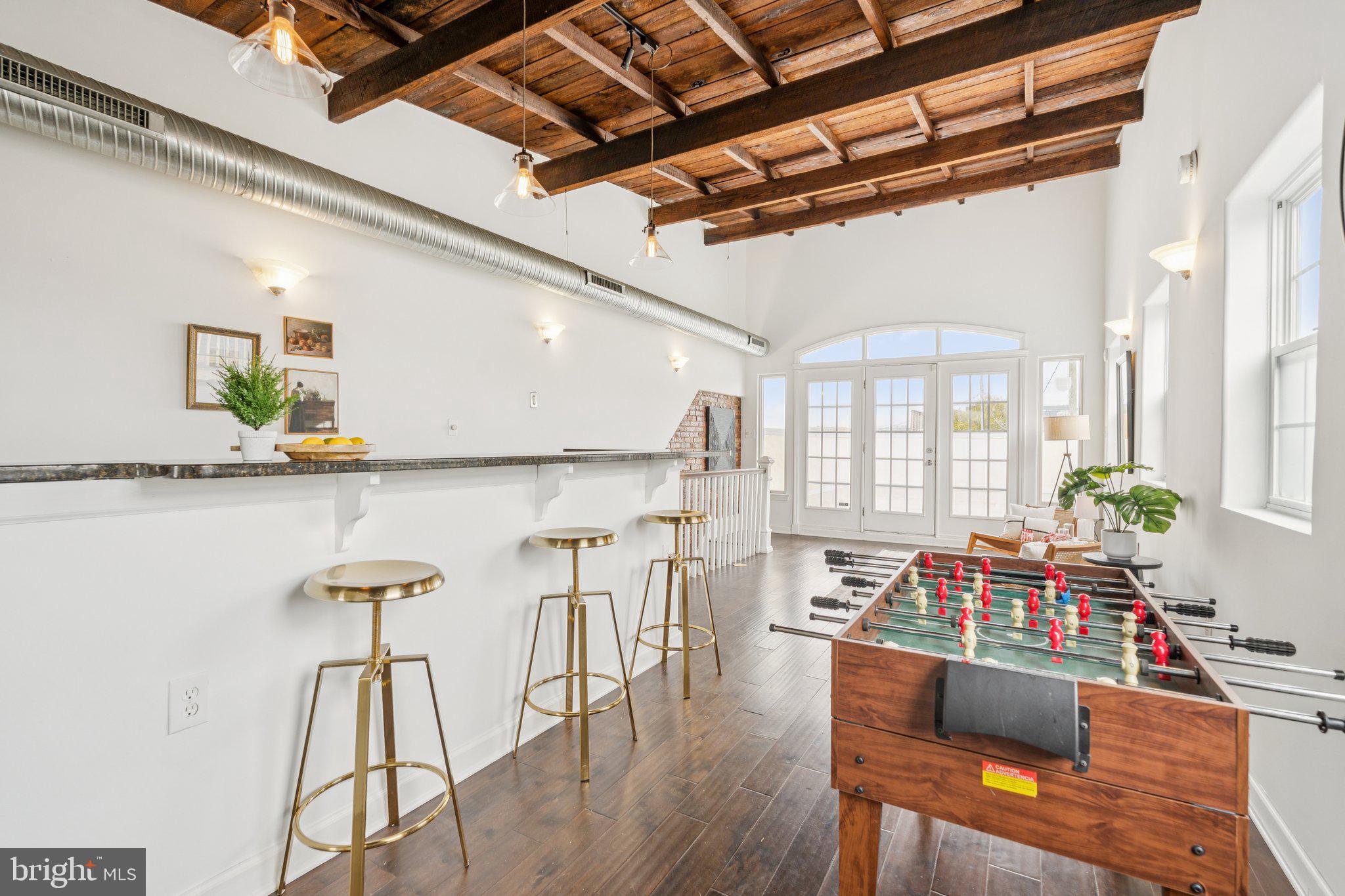 Welcome to 801 S Rose St! This expansive 3-level end-unit townhome blends charm, style, and an unbeatable location! Just steps from the Square, the waterfront, and your favorite coffee spot, Cafe Dear Leon or OneDo. This stylish townhome features a kitchen that opens seamlessly to the dining area and sun-filled living room, creating the perfect layout for everyday living, effortless entertaining or cozy nights in. Upstairs, on the second-level you’ll find two comfortable en-suite bedrooms, including a primary suite, plus laundry close at hand for everyday ease. The third-level is designed for fun and flexibility featuring wood-detailed ceilings, a second kitchen, an additional bedroom and bath, plus direct access to an incredible rooftop terrace, which sets the stage for unforgettable gatherings. With exposed brick, hardwood floors, modern updates, and a layout made for entertaining, this home is more than a place to live, it’s your front-row seat to all that Canton has to offer! Additional highlights include a spacious main-level mudroom with additional storage, exposed brick accents, and gleaming hardwood floors throughout. Recent upgrades include: new rooftop terrace surfacing (2024), new appliances (washer/dryer 2024, dishwasher 2021, upstairs fridge 2022), new roof (2023), and new HVAC (2023).