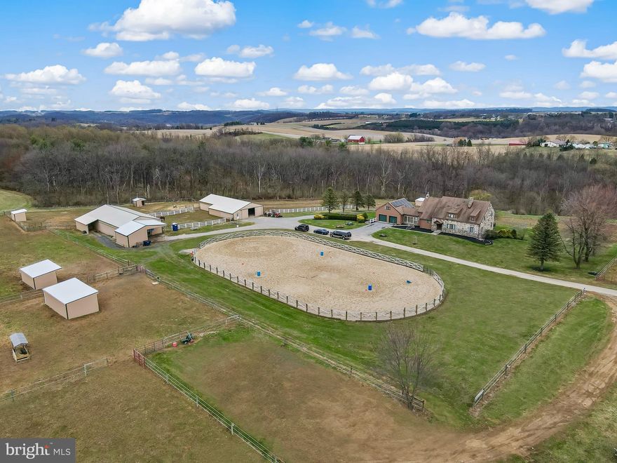 A long & winding driveway leads to Ravens Run, an impressive turnkey horse farm/boarding facility on 39.6 lush & open acres which are NOT preserved. The idyllic setting with mountain views & rolling pastures is what dreams are made of. Acreage is NOT preserved so an opportunity sell development rights. Two barns house 25 well-appointed box stalls & a large tack room. Five spacious turnouts & 4 run-in sheds. 100 x 200 sand riding ring with sand footing & new fencing. 60’ round pen. Riding trails & stream running through lower side. 

The residence is a 5 bedroom, 4 bath colonial w/ locally sourced mountain stone on some of the exterior. Central Air. A well proportioned slate foyer sets the stage for this extremely spacious home. The eat-in kitchen has solid wood cabinets, upgraded countertops and backsplashes along with stainless steel appliances and a built-in double sink. Formal dining room with elevated brick fireplace. French doors off foyer lead to an ample size living room featuring locally sourced stone fireplace with a gas insert. A bonus room that can serve as an office or 6th bedroom is next to this room. Handsome family room with tongue & groove walls is equipped with a brick hearth and gas stove. A ¾ bathroom is in this area. An all season sunroom is located off this room & on one side leads to a new 12’ x 44’ composite deck which overlooks back pastures. A massive handrail from local trees leads to the 2nd floor where a master suite + 4 bedrooms and full bathroom complete this level. Large walk-out basement is finished with a full bathroom, gas fireplace & tiled area for a potential kitchen. This space is perfect for creating additional living quarters. Large laundry room with chute from 1st & 2nd floors. Genrac whole-home propane guarantor that supplies a majority of the property during power outages. Multi-level 4 car garage with loft for possible apartment. Large fenced back yard for pets or children. Permanent chicken coop in rear for easy egg collection. Solar panels on roof are leased & transferrable.

EQUESTRIAN COMPLEX
Upper barn is 36 x 80 & has 16 (10x12) stalls w/ rubber mats. Large addition in front for hay, feed & bedding storage. It also has an overhang to accommodate vet trucks in bad weather.
Lower barn is 32 x 80 with 9 (12x12) stalls and an area used for storing tractors, UTV & tools. Large tack room with 30 spaces.
100 x 200 sand arena with fencing installed last year.
60 foot round pen.
5 turnout paddocks with multiple gate system to open & close paddocks to allow rotational grazing.
One paddock is used for pasture board and has a 15 x 30 run-in shed.
Other paddocks have similar sized run-in sheds.
2 upper paddocks share an automated waterer.
9 acre pasture currently used to grow hay – managed by local farmer.

List of equipment for sale & general property specs available upon request.