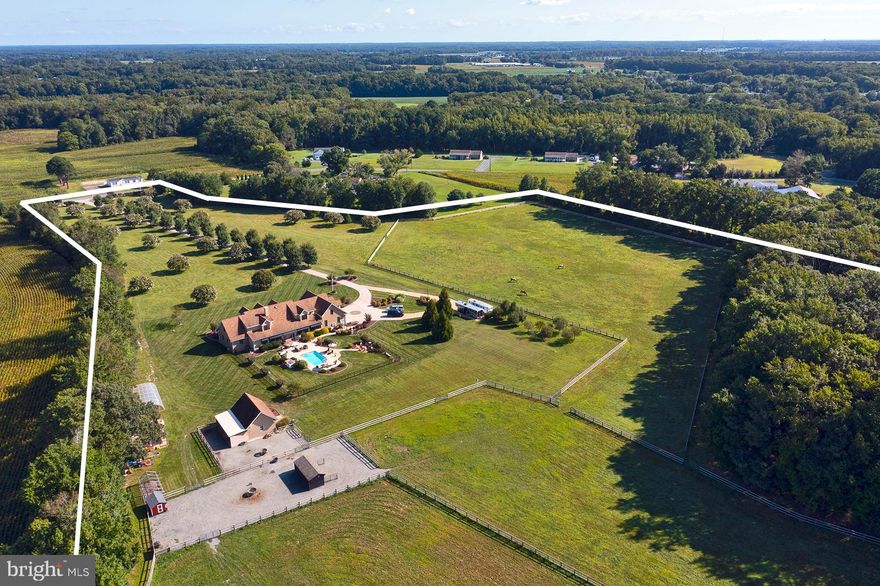 Welcome to Riptide Ranch! 
A Homesteading paradise or lovely event venue opportunity, just 15 miles from the beach!
This one-of-a-kind, homestead is located in Bishopville.  Every detail has been considered in the design and construction of this home. You will be mesmerized as you drive down the long tree-lined lane and approach this magnificent 5-bedroom home situated on over 26 acres, including 8 acres that are wooded.
The large front porch, with a queen size swing bed and fire bowl, is perfect for relaxing evenings or enjoying the company of friends.  
Upon entering the home, you are sure to appreciate the unique Tigerwood flooring throughout the first floor, the grand curved staircase with custom railings, and living and dining rooms.  The main living space showcases vaulted ceilings, exposed beams and a new stone fireplace with a pellet stove insert.  Additionally, on the second floor there is a huge bonus room that can be used for entertaining and can be outfitted as a gameroom, theater, or whatever you like.  The spacious kitchen is truly a chef's dream come true as it offers a walk-in pantry w/ additional beverage refrigerator and extensive shelving, vintage custom-made island, butcher block, Wolf appliances including gas stove with commercial grade exhaust, double ovens, dishwasher and ALL soft close cabinetry.  
French doors lead to the spectacular outdoor living spaces as you retreat to the picturesque backyard/ porch area offering ceiling fans, a firepit, hot tub, and a heated saltwater pool!  There are also three equestrian paddocks, raised gardens, a chicken house, a green house on the estate, and fruit orchard with Pear, Apple and Cherry trees.  A hay barn provides ample storage for all farming equipment. 
Large sunroom is a tranquil space of natural light with a wall of windows. 
A steam room and guest bath located off the sunroom. 
Access to the conditioned concrete crawl space is conveniently located in the utility room.  
Attached garage has space for multiple vehicles.  
RV Pad and 30V RV hook up recently added.  
New high speed internet line installed. 
Gutters recently cleaned and power washed.  
Spacious walk-in closets and ample storage throughout this home.

The list of features and upgrades goes on.   Be sure to check out all of the photos and call today to make an appointment!  Only pre-qualified buyers please.