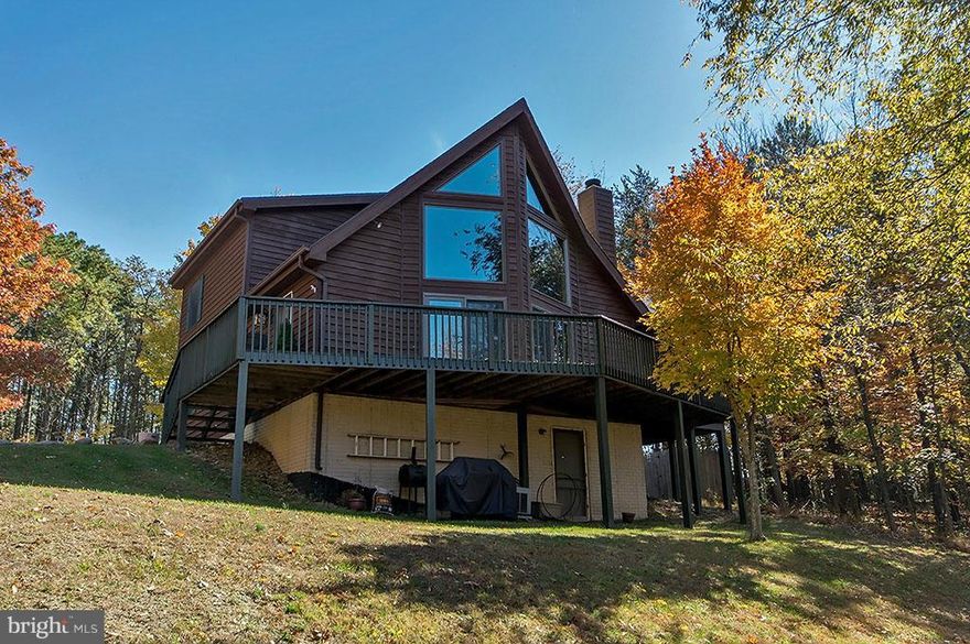 Wooded haven for your weekend getaway!  Ships bow cedar chalet boasts an inviting great room featuring a wood burning fireplace, open floor plan to kitchen with granite counter top & cherry cabinets. French doors in the loft lead to your master bedroom oasis & adjoining master bath featuring free standing acrylic tub, separate shower, & western cedar walls. Wraparound deck + screened deck + views!