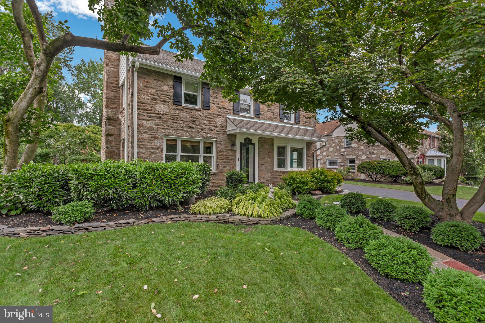 Welcome to 811 Stratford Avenue — A Classic Stone Colonial in the Heart of Elkins Park
This stunning stone Colonial home offers timeless charm and exceptional living space, all nestled on one of Elkins Park’s most sought-after tree-lined streets. With captivating curb appeal, a traditional floor plan, and elegant finishes throughout, this home seamlessly combines historic character with thoughtful modern updates.
Step inside to find beautiful finished hardwood floors, a classic stone wood-burning fireplace, large bay windows, recessed lighting, and massive kitchen pantry cabinets. Thanks to its southern exposure, the home is flooded with natural light throughout the day. Off the far corner of this home there is a magnificent sun room with extra sun light from the skylights. This is on room you will spend a lot of time in enjoying.
The spacious, updated Eat-In Kitchen is a chef’s dream — featuring granite countertops, ample cabinetry, built-in appliances, a gas range, and a mudroom area with side entry access. Adjacent to the kitchen, enjoy a cozy den for quiet moments and a huge Family Room with vaulted ceilings, a skylight, and panoramic windows offering serene views of the oversized backyard.
Outside, the grounds are a true highlight — with spectacular professional landscaping that enhances the home's beauty year-round. The expansive yard includes a Sport Court with night lighting, perfect for basketball/pickleball or play, as well as a charming flagstone patio and walkway ideal for entertaining or unwinding in your private outdoor oasis.
Upstairs, the home continues to impress with a generous hallway, convenient second-floor laundry, and five large bedrooms — including a lovely Primary Suite and an en-suite bath featuring sleek tilework and frameless glass shower doors. Plenty of rooms for either a large family or additional space for a home office. The finished attic provides additional living or storage space, while the clean, basement offers a powder room and future potential.
Located within walking distance to Elkins Park and Melrose Park train stations, Myers Elementary, and all the shops and restaurants in downtown Elkins Park — this home offers the perfect blend of classic elegance, modern comfort, and prime location.