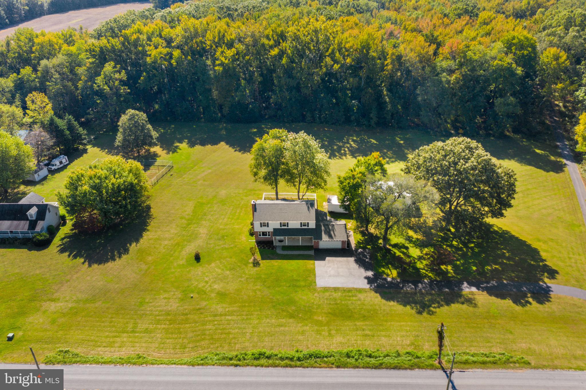 A RARE gem in Southern Maryland!Situated on over 20 acres, this jewel is just a stone's throw away from Goose Bay Marina and the Potomac River. As soon as you arrive, you'll be greeted by the pride of ownership that radiates from this epic property. Outside, you'll find a barn 22 x 34, wood shed 15 x 17 and a shed 16 x 30, perfect for accommodating boats, cars, or RVs. The owners have truly taken care of this home, giving it a facelift over the years with major upgrades. From the architectural roof, siding, windows, shutters, gutters with aluminum mesh, leaf guards, and downspouts, to the completely remodeled kitchen, no detail has been overlooked. The kitchen remodel is sure to impress even Martha Stewart herself! Featuring 42-inch KraftMaid Roman fox Chase Cherry cabinets with crown molding, soft-close drawers, and all stainless steel appliances, it's a dream for any aspiring chef. The blue ProGranite countertops, Duraceramic Flooring, and the stainless steel mosaic w/ gemstone black glass mosaic backsplash add a touch of elegance. Upgraded faucets and light fixtures complete the picture. The homeowners have also considered the future by installing a new 50-gallon hot water heater and a water conditioner treatment system in the basement. All doors have been replaced (to include the garage) blinds in all bedrooms and bathrooms, fresh paint and new carpet downstairs, lets not forget that the heat pumps with electric backup have been installed, along with upstairs ductwork and programmable thermostats. Inside, all the rooms are spacious and inviting. The main level boasts a large family room with a woodburning insert, a versatile living/flex area, a gourmet kitchen, and a huge gathering room. Upstairs, a wall was removed to create an open space in the fifth bedroom, and both full bathrooms have been renovated. The owner's suite even includes an owner's closet in the adjacent room. The basement offers a blank canvas for you to make your mark. It's unfinished but has an outside exit and brand new sump pumps. Outside, the grounds are a park-like setting, watching Mother Nature work her best as you relax in the screened-in, no-maintenance porch with storage area underneath. There's also a lovely paver patio and a small fenced area for your furry friends. With so many more amazing upgrades, this property truly is a once-in-a-lifetime opportunity.