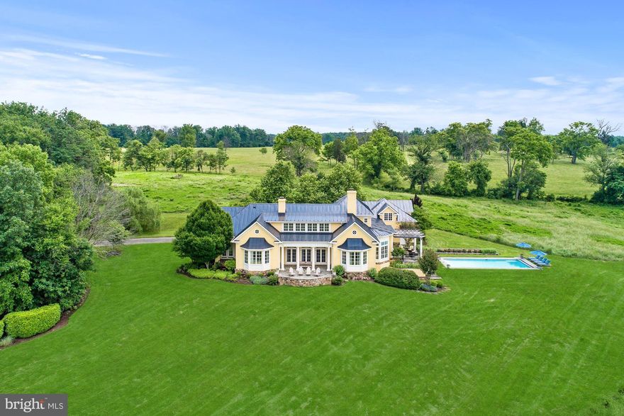 Custom 5000+ sq ft home on 50 acres with gorgeous views! Open floor plan in European Country design.  Gourmet chef's kitchen, sunken living room, den and sunroom.  Main level master suite and full walk-out basement.  Outdoor features include flagstone porches, heated pool, 2 car garage with 1 bed apartment above.