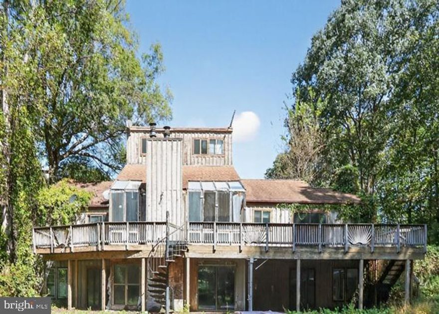 Perfect canvas for the visionary buyer or seasoned investor. Situated on 5 acres +/-, this contemporary style home offers three bedrooms and three bathrooms. Interior features include wood beamed ceilings in the den with built-ins, living area has skylights and a stone fireplace, peninsula kitchen with ample storage and workspace. Made for outdoor fun and entertainment, there is an inground pool and gazebo/pavilion. Work is required for move-in, but the opportunity is there to transform this house into the showcase home it once was.