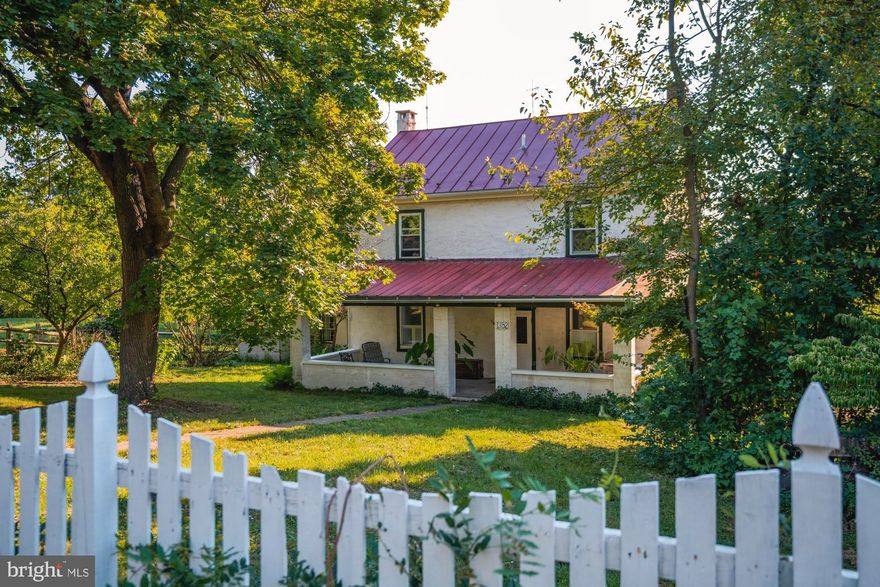 Surrounded by scenic parkland and recreational space,  this attractive 2 acre farmette  presents an exceptional opportunity to enjoy a country lifestyle in an historic farmhouse with a multitude of outbuildings including a charming summer kitchen and a giant bank barn. Greet guests through a picket fenced yard and deep front porch.   The circa 1800s stone home features deep windowsills, a curved staircase, walk-in fireplace, exposed wood floors, and vintage hardware.  The first floor includes a bright entrance foyer, large living room, modern eat-in kitchen with island, high ceiling, and solid surface counters and commanding views of the back yard.  Two additional rooms, serving as bedrooms or in other capacities, a walk through pantry, and a full Bathroom are also on the main level.  A charming curved staircase leads to the second floor which features 3 additional bedrooms (for a possibility of a total of 5 bedrooms) and a second full Bathroom.  Stairs lead to the large attic.  There's plenty of extra storage space in the full basement which includes a utility bathroom .  Whether you are a hobbyist, collector or craftsman, an array of unique outbuildings will give you all the room you could possibly want.  The giant barn, boasting a footprint of over 5000 square feet,  extensive electrical service upgrades, multiple levels, bays and storage areas, can serve a plethora of uses for the new owner.  Surrounded by the beautiful Hollenbach park, recreation including walking trails and open playing fields are literally just outside your door.  Yet, the home is also within just a few minutes of many shopping opportunities and major commuter routes. A setting like this is truly hard to match.