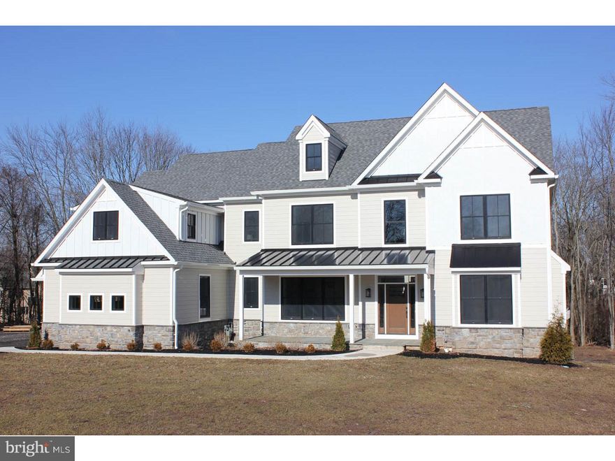 The Modern Farmhouse - Beautifully oriented on a 1.2 acre site, this 3 story, 5 bedroom, 3.3 bath, 6,215 square foot home is replete with high end amenities and mill work. As soon as you step onto the flagstone porch you will be welcomed into a contemporary estate. Gleaming hardwood floored foyer leads you into a 12 ft high cofferred ceiling family room with custom wood fireplace. Side-entry mud room with custom built cubbies and powder room. Full overlay custom kitchen cabinets with soft-close drawers and doors, 48" full size commercial Thermador range top with griddle and convenient pot filler. Thermador built-in refrigeration with icemaker and Kohler 45" Stages stainless steel sink. 12 ft  island  perfect for kitchen prep and entertaining.  Butler pantry with dishwasher, wine refrigeration and sink, china closet plus walk in pantry with barn door.  Picturesque breakfast room with wonderful sunlight that opens onto a rear deck surrounded by Lower Gwynedd township trail and green space.  Bright living room with fireplace. Dining room with tray ceiling. 1st floor contains finished in place hardwood floors and oversized crown molding throughout, plus 7 ft high doors.  Master bedroom with 10 foot tray ceiling, his and her's private closet with sitting room, master bath with Mitra tub, oversized shower with rain head, dual shower heads and bench. Master bath also includes private water closet, oversized double-bowl vanity and built-in make-up counter. 2 bedrooms with Jack-and-Jill bath. Princess bedroom with full bath. Laundry with granite tops and laundry sink next to master bedroom, 2nd floor loft a perfect get-a-way to relax.  Third floor 5th bedroom with closet or for extra storage.  Finished walk-out lower level with powder room and 4 full windows, with french doors to rear yard. 1st and 2nd floors have finished in place hardwood floors with recessed lighting  and designer lighting package throughout, Solid doors on 1st floor beds and baths with oil rubbed bronze hardware.  Andersen 400 series Black exterior double-hung windows (white interior),  Hardi-plank cement board siding with board and batten detail and stone veneer water table.