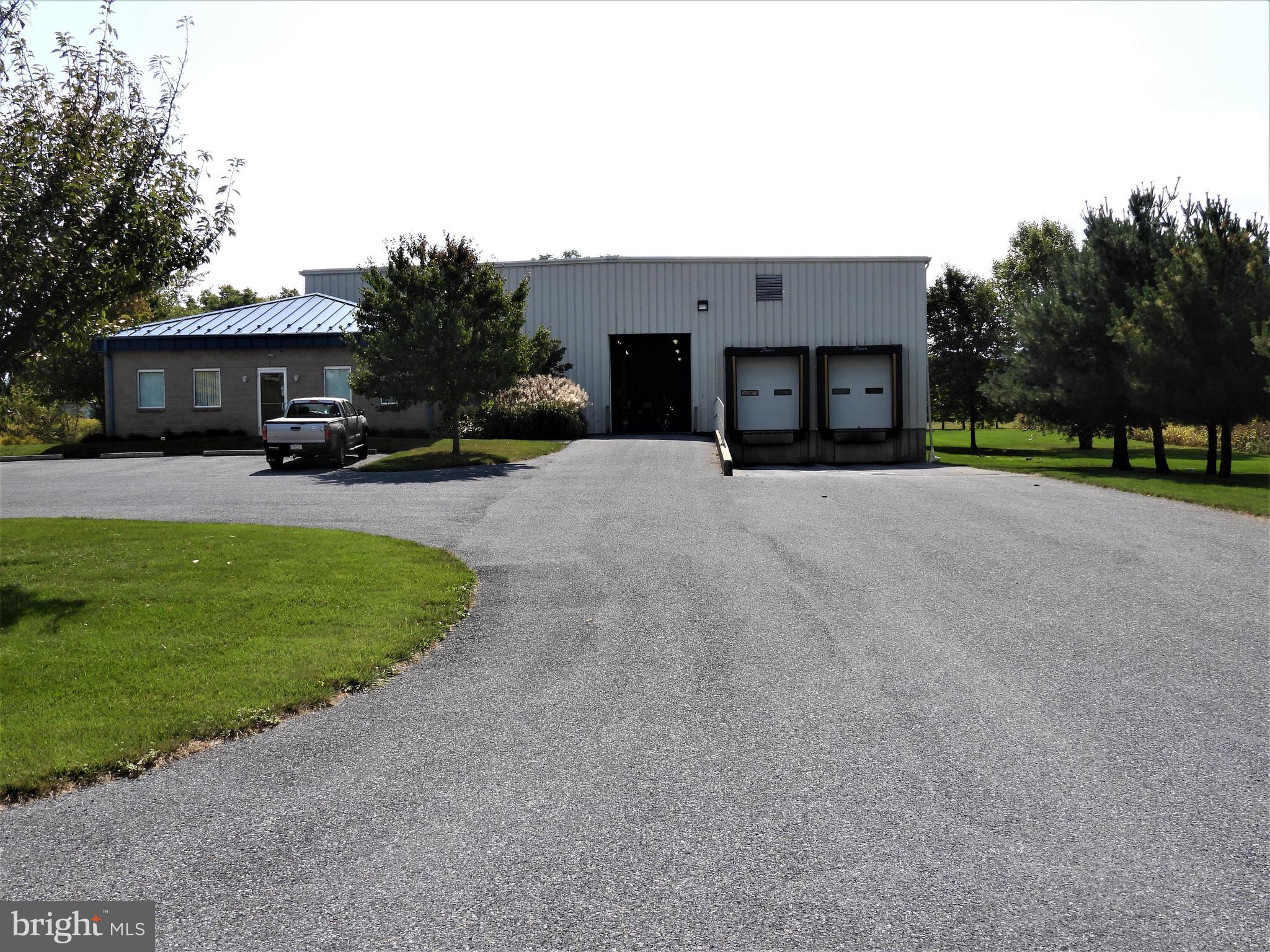 Warehouse with 20' ceilings, two loading docks and 1 drive in door, 2 walk in coolers built in place and 845 SF of office space.