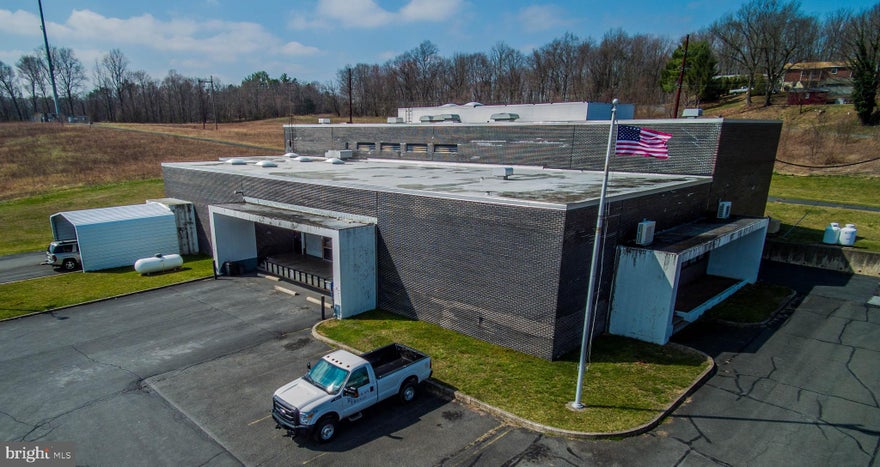 .Brick office warehouse building on large level lot allowing opportunity for expansion of the building.  The structure consist of two levels with approximately 12,000 sq. ft. on the first floor and approximately 5,580 sq. ft. on the second floor.  Approx. 6,400 sq. ft. 1st floor with 16'3" clean span ceiling height.  12'7" on majority of second floor.  Three covered loadings area with two dock doors.  One drive in door and detached storage building.  The building is climate controlled and sprinklered.  Two ton lift crane to second floor.  440 3 phase electric with two 800 amp services GS3 and GH3. Set of Engineer Drawings Available.  Plenty of on site paved parking.
