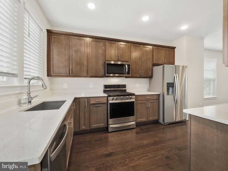 This meticulously well-maintained END UNIT townhome is exquisite, with three levels to spread out! Two bedrooms on the third level are equipped with full-suite bathrooms with plenty of closet space.  The second level has beautiful  5-inch mahogany hardwood flooring with a half bath with access to the balcony.   The lowermost level has an additional full bathroom and a third bedroom.   This Townhome features luxury Kitchen Cabinets, Beige Quartz Countertops, and Whirlpool Stainless Steel Appliances. Luxury Ceramic Tile Packages in all Bathrooms and Private En-Suites for all Bedrooms. 
 BEING NORTH EAST FACING with The open-concept floor plan allows MAXIMUM NATURAL LIGHT from THREE sides of your new home! 
 The SMART washer and dryer are relatively new. CUSTOM BLINDS. CENTRAL HUMIDIFIER.   VIDEO DOORBELL for SECURITY
It is conveniently located and within walking distance of great restaurants, Safeway, Wegmans, entertainment, Top Golf, and Regal Cinemas. The Germantown Transit Center and I-270 provide a quick commute to Washington, DC! 
Make sure you schedule your private tour ASAP for your chance to snag this beauty all for yourself! Please Submit all offers by 10/19/2022 at noon.