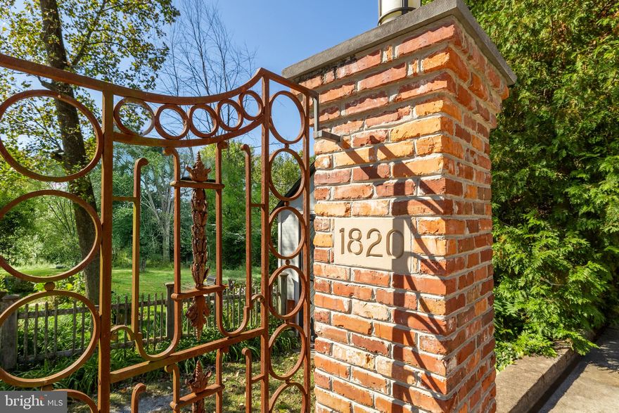 A long driveway framed by lighted brick pillars leads to a gracious paver motor court, introducing 1820 47th Place NW. Constructed in 2010 by a collaboration between renowned builder Chryssa Wolfe and acclaimed Hanlon Design Build, the home, situated in the heart of Berkley with STUNNING RESERVOIR VIEWS, represents the very cutting edge in luxurious, environmentally-conscious living. Spanning over 6,800 finished square feet of top-end finishes and expert workmanship, the main entrance is via an arched solid wooden door prominently perched above the motor court, revealing an elegant central foyer lined with contrasting wainscoting complementing thick crown moldings overhead and neutral hardwood flooring throughout. Formal spaces occupy one wing of the main level, with the living room’s roaring gas fireplace establishing a warm ambiance. Its adjacent office features a wall of built-ins, French doors to a private balcony, and doubles as a peaceful retreat. Opposite is the dining room with graceful ceiling trim, built-in speakers, and a step down to the rear patio for an al fresco experience. A true butler pantry adjoins the kitchen and includes a spectacular full-size paneled Thermador wine fridge. The kitchen features a comprehensive suite of commercial-grade Thermador, SubZero, and Miele appliances to appease any chef. Its sophisticated contrasting cabinets, granite countertops, built-in bench, sophisticated audio and lighting systems, and patio access create a sophisticated ambiance fitting as the heart of the home. A large, adjacent family room with coffered ceiling, roaring gas fireplace, private balcony, and built-in bookshelf completes the main level. Ascending the grand staircase or utilizing the FOUR LEVEL ELEVATOR reveals the upper level. The primary bedroom is nestled in its own wing, flooded with natural light and reservoir views. Dual walk-in closets with extensive shelving and a sumptuous ensuite bath with double marble vanities, a marble-lined Jason tub, large walk-in shower, as well as separate linen and water closets complete the oasis. A second bedroom features an ensuite bath, while two additional bedrooms share a jack-and-jill – each ample in scale and featuring built-in bookcases. A convenient laundry room completes the level. A large finished bonus room, full bath, fifth bedroom, and ample storage occupy the top level, creating the ultimate in flexibility. The lower level has its own separate portico exterior entrance, leading to a mud room with built-in cubbies and access to the attached two-car garage, including a Tesla charger. The large recreation room is multi-purpose, with a wet bar, fitness area, and seating area. A sixth bedroom suite, ideal for an au pair or in-law suite, completes the lower level. Behind the scenes, sophisticated systems create a state-of-the-art, energy efficient lifestyle. Multi-zone Geothermal HVAC, Windsor Windows twin 80-gallon water heaters, Honeywell Security, Lutron Lighting, and Sonos Sound are a testament to the meticulous quality of construction. Out back, the private, wooded, fenced-in yard is an artful combination of meticulous landscaping and extensive hardscaping. A large patio with a fire pit is ideal for large outdoor gatherings, while a shaded, turf-lined lounging area is tucked away under a verdant canopy. With its highly sought-after location convenient to Georgetown’s esteemed shopping, dining, and entertainment, 1820 47th Place NW represents a rare blend of modern luxury with a classic setting.