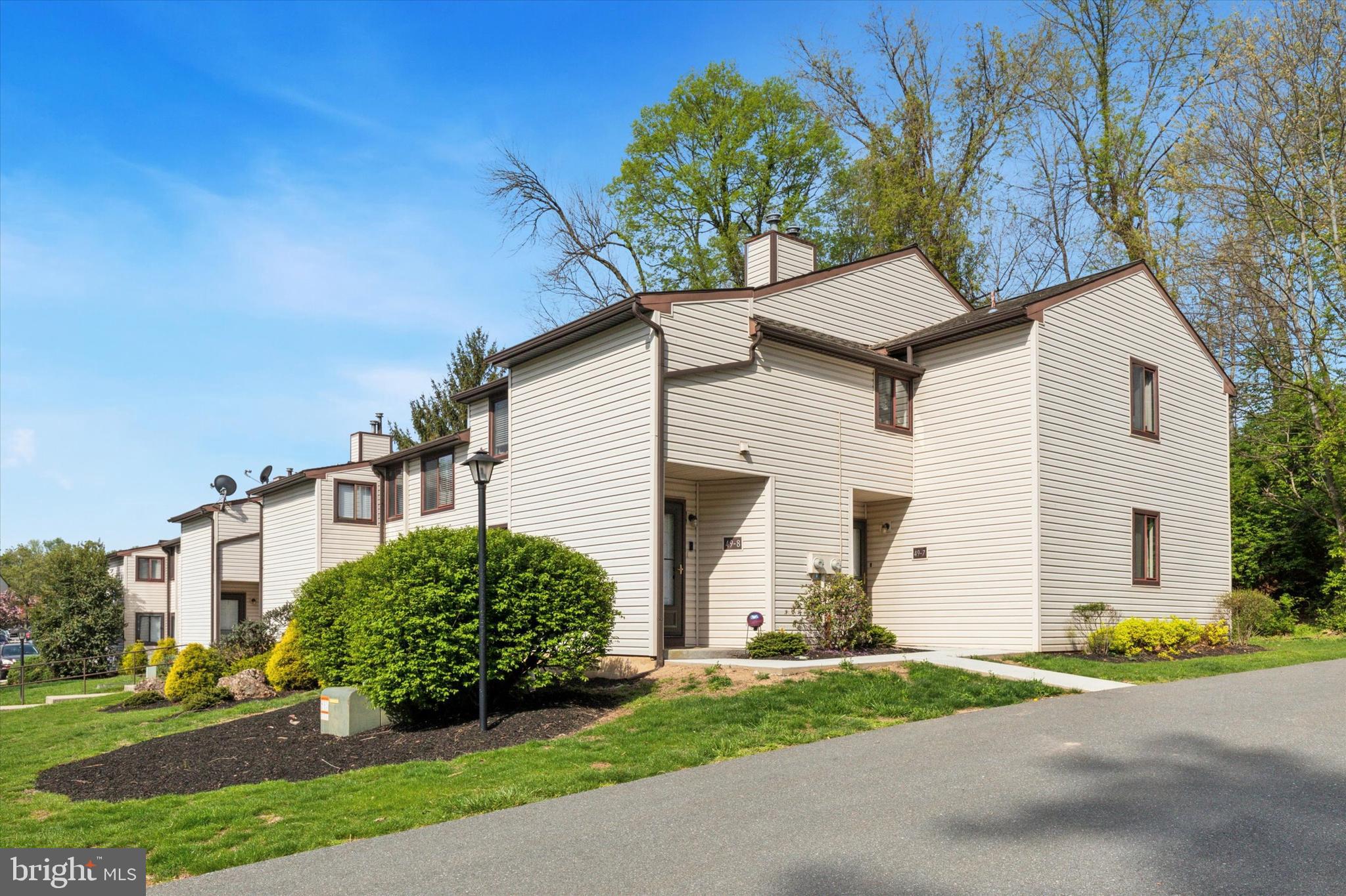 Enjoy peaceful, care-free living in this delightful and spacious end-unit first-floor condo nestled in the sought-after Laurel Springs community at 49-7 Holly Drive in Reading. With 2 bedrooms, 2 full baths, and 1,161 square feet of stylish living space, this home has been thoughtfully renovated to offer fresh paint throughout, plush new carpeting, and polished tile flooring. The galley-style kitchen includes all appliances and flows seamlessly into the sunlit dining area and spacious living room. Sliding glass doors open to your private rear patio — the perfect place to relax or host a summer BBQ, with scenic wooded views offering natural privacy. The in-unit laundry room includes both washer and dryer, and the community's in-ground pool is an ideal summer perk (membership fee required). Other amenities include Club House, Tennis and Basketball Courts, and a Playground. Located close to nature trails, Bridge & Walking Trail, Crystal Cave, Santander Arena, restaurants, shops, and the Berks County Heritage Center, this home combines the tranquility of nature with convenient access to vibrant local culture. Whether you’re downsizing or seeking your first home, this turn-key condo is ready to welcome you home.