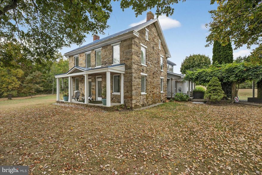 Welcome to 464 Locust Lane, truly an inspired retreat for living, working, and creating. Set on more than 26 acres of rolling countryside, this beautifully updated stone home offers a rare blend of character, comfort, and opportunity. Designed for both relaxation and inspiration, it’s the perfect sanctuary for a creative retreat or a life well-lived close to nature. Inside, the residence features 4 bedrooms and 3 baths, including a serene main-level primary suite designed for comfort and ease. A chef’s kitchen with premium finishes flows seamlessly into a light-filled atrium - an inviting space that feels like the heart of the home, ideal for gathering, daydreaming, or sketching out your next big idea. Beyond the living spaces, the property opens endless doors for imagination. A 4,800 sq. ft. shop with 1,800+ sq. ft. of finished interiors is ready to become a studio, gallery, workshop, or business headquarters. A tractor shed adds practical utility, expanding the property’s potential for storage, projects, or everyday convenience. Zoned for mixed use, this property is a canvas awaiting your imagination - whether as a serene homestead, an inspiring creative retreat, or a place where work and passion thrive side by side. Here, country living meets endless possibility. Discover a one-of-a-kind property that doesn’t just house your lifestyle - it elevates it. Schedule a private showing today!