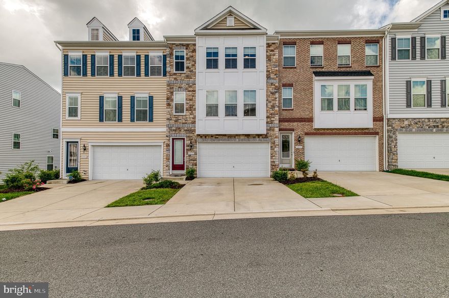 Price improved!!! Now listed at $20,000 under the most recent sale in the neighborhood. Luxury 4-bedroom, 3.5-bath, garage townhome. Tucked away on a quiet side street, this K. Hovnanian townhome was built in 2021 and is loaded with upgrades. Bump outs on all 3-levels, provide 2,840 square feet of living space with a 400 square foot 2 car garage- with storage area. Highlights include a chef's kitchen with a massive island, 42-inch tall cabinets, upgraded appliances, hardwood floors, main floor office/playroom and a Trex spacious deck. The primary suite offers luxury with a private deck,, bathroom with double vanities, oversized shower and two walk-in closets. The laundry room has a utility sink and extra cabinets. The lower level has a 4th bedroom or recreation room with a walk-in closet, and another full bathroom. The home is energy efficient with special energy conserving insulation, 92% energy efficient gas furnace, low e vinyl pane thermal double pane windows and programable thermostat. Smartcom wired technology with video doorbell, alarm system, exterior mounted garage door keypad and wall mounted TV wiring. 30-year architectural shingle roof upgraded brick front and low maintenance vinyl siding make this home easy to care for! The neighborhood HOA fee covers lawn maintenance including mowing, leaf blowing, and seasonal lawn maintenance! The neighborhood has playground and walking paths and is walking distance to restaurants, ice cream shops, Starbucks, spa, bank, grocery store and various other businesses! Intermixed in the neighborhood are open parking spots for additional visitors and tons of green space. Highly sought after schools Penn/ Beville/ Colgan High School. Close to commuter routes, PWC parkway, 95, 28, 66 and convenient to VRE station, Quantico, and Ft. Belvoir.