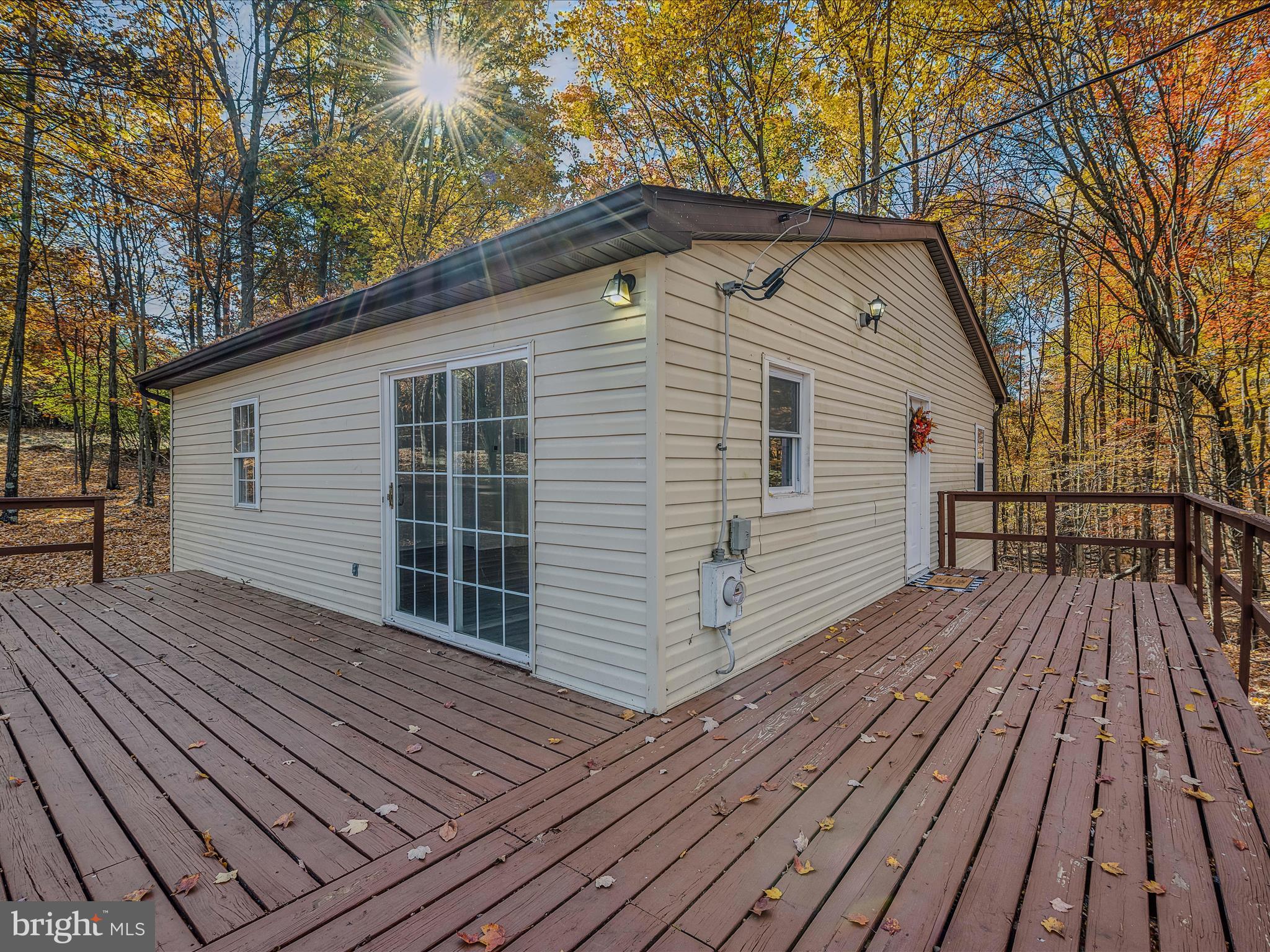 Escape to the tranquility of rural living with this charming 3-bedroom, 2-bath home nestled on 3.75 private, wooded acres in Berkeley Springs, West Virginia. With 952 square feet of cozy living space, this home offers the perfect blend of comfort, thoughtful upgrades, and peaceful surroundings. Inside, you’ll find stylish finishes including new quartz countertops, stainless steel appliances, durable LVP flooring, and plush carpeting in the bedrooms. Recent improvements include a new roof, newer HVAC system, and a comprehensive basement waterproofing system featuring an internal french drain, sump pump, and drain tile—designed to keep your home dry and protected. Even more updates have been made to the plumbing system, including a new submersible well pump, pressure tank, and well diagnostics. A complete crawlspace renovation adds to the long-term value and durability of the home. Step outside to enjoy the beautiful front deck, surrounded by peaceful trees—ideal for relaxing mornings or quiet evenings. Whether you’re looking for a weekend escape or a full-time home, 33 Maple Lane is the perfect place to unwind and enjoy nature. Don’t miss your chance to make this beautifully updated country retreat your own!