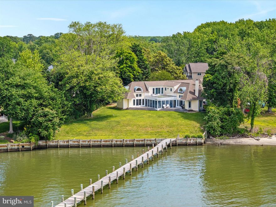 Stunning waterfront retreat nestled along the serene shores of the Rhode River offer the perfect blend of peaceful seclusion and convenience ** Meticulously custom designed for incredible panoramic water views from all rooms, enhanced by large windows that flood the interior space with natural light ** Wake up to panoramic river vistas from the primary bedroom which features an en-suite bathroom and a private balcony overlooking the water—a perfect sanctuary to unwind ** The oversized 3-bay garage includes a workshop with plumbing and upper-level area which can be finished to create additional living space ** There are 2 driveway entrances, circular driveway and multiple parking areas for company ** Newly installed Generac Generator runs off owned propane tank ** There is no mandatory HOA and flood insurance is not required ** Take advantage of direct access to the Rhode River with your own private pier, perfect for boating, fishing, crabbing and outdoor entertaining ** The pier accommodates multiple boats plus a 10,000 lb High & Dry boat lift ** The mean low water depth of 9 feet accommodates any boat with a deep draft ** Enjoy fast access by boat to the Chesapeake Bay without any 6 knot restriction ** Directly across the Rhode River facing West are thousands of acres of wooded land owned by the Smithsonian Environmental Research Center which allows for a more serene water view and gorgeous sunsets ** The Cloverlea community offers a waterfront play area and space to launch kayaks ** The Cloverlea Boat Club, with additional membership fee, includes a small beach, pavilion, boat ramp, and slips ** Enjoy close proximity to top-rated schools, shopping centers, dining establishments, and recreational parks ** The 300-acre Beverly Triton Nature Park is nearby with Bay views, a play area and 5 miles of natural trails ** Easy access to major highways make travel to Baltimore, Annapolis, or Washington DC, a breeze ** This waterfront gem combines luxury, functionality, and an unbeatable location ** Whether you're seeking a serene retreat or a vibrant space for entertaining, this home caters to all ** Schedule your private tour today and envision the unparalleled lifestyle that awaits you