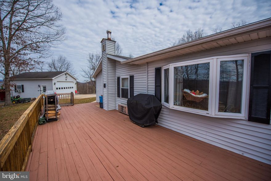 This well taken care of property has it all surrounded by tranquility. It has been gently taken care of over the years with love. Sip your coffee on the screened in porch or on the large deck while listening to the wildlife. Enjoy the two separate living areas to spread out. It's updated and ready for you. The garage has a car lift, heat and electricity. A workshop sits behind the garage and a storage shed behind it. There is even a she-shed with electricity. Everyone has a space. The generator can  be plugged into the house for emergencies.  Don't miss this one of a kind property. AHS Shield Essential 1 year home warranty.