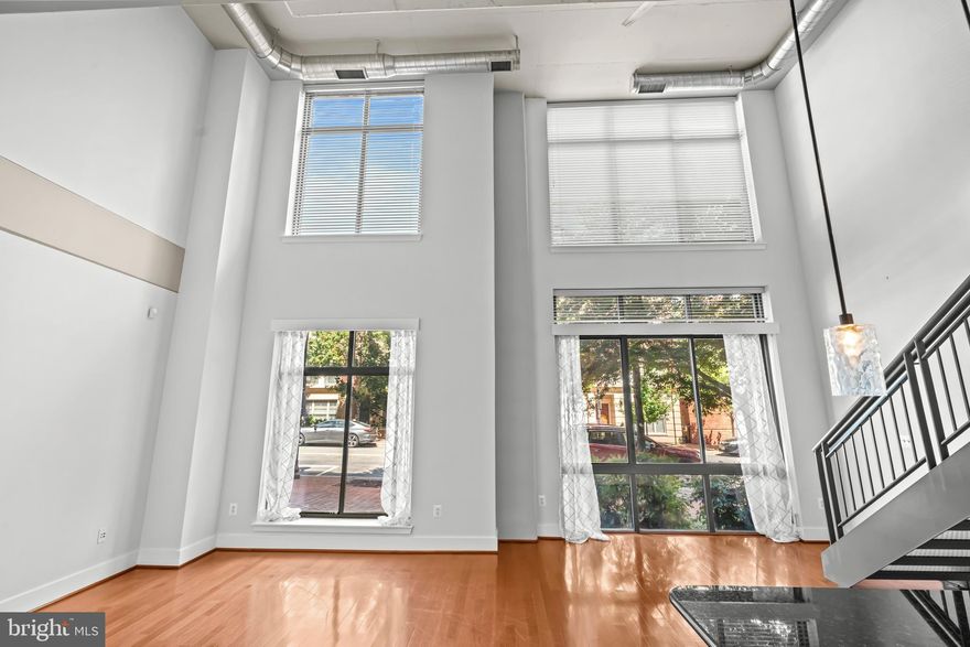 Live in 22314 Alexandria's premier zip code! Possible assumption of VA loan at 4.625%. Welcome to Carlyle Square.  Near the PTO and Metro accessible from King Street metro this condominium is perfectly located.  All the best of Old Town is just outside your door.  With a two story loft this unit is spacious.  With a half bath on the main and a full bath on the top-level bedroom suite this home is a perfect example of modern luxury.  Washer and dryer in unit on bedroom level. Two story floor to ceiling windows provide abundant natural light and an enormous open air feel.  The gourmet kitchen has stainless steel appliances, a breakfast bar, pantry storage, and plenty of cabinets. Easy access into the secured building from the Ballenger Street side gate. This breezeway leads to a wonderful interior courtyard for the owner's private use.  Tables with umbrellas, mature plantings and a fountain make this space a tranquil outdoor area for owners to enjoy. One of the largest storage cages for the owner of this unit will provide plenty of storage, approximately 10x5x6. Garage parking with one deeded parking space with dedicated EV charging.  Whole foods, Starbucks, Gin Ramen, shops and restaurants are just a block or so away. You don’t need a car.