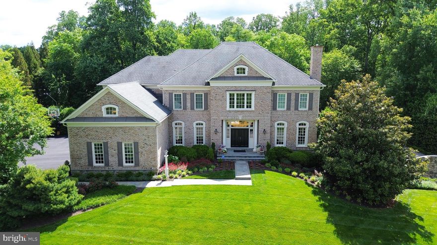 Welcome to this exceptional home offering refined living, inviting spaces and spectacular grounds! Follow the flagstone entry path and step inside to a stunning two-story foyer. A sweeping curved staircase and exquisite arched entryways lead to the formal living and dining rooms. The foyer also offers a view into the breathtaking great room featuring coffered ceilings, floor-to-ceiling windows, and a beautiful custom fireplace mantel. The spacious dining room connects to a butler’s pantry with a wine chiller and glass front cabinetry. The kitchen is a true centerpiece with professional grade appliances, custom cabinetry, a generous center island with bar seating, laptop desk nook and convenient back stairs. The kitchen flows seamlessly into the breakfast area, richly appointed pub room, impressive great room and opens to the top of the line Zuri deck. The main-level office offers privacy with french doors and abundant natural light. Upstairs retreat to the primary suite and savor your morning coffee on the upper deck or in the sitting area. Enjoy the renovated spa-like primary bathroom with 
a soaking tub, walk-in shower with multiple body sprays and dual vanities. Two expansive walk-in closets with custom built-ins complete the primary suite. The upper level also features two private en-suite bedrooms, one is a turret room and features a gorgeous curved reading bench with storage space underneath. The other 2 bedrooms are connected with a Jack and Jill bathroom. The walk-out lower level is designed for everyday living, relaxation and entertaining with a spacious recreation room, billiard room, expansive fitness room, guest bedroom and full bathroom. A highlight of this home is the backyard oasis for relaxing and entertaining. The lush and professionally designed grounds surround the serene, salt water  pool,  which is heated for year round fun.  The outdoor conversation area, stone fireplace and outdoor kitchen complete the luxurious backyard. A half bathroom is accessible for pool users and is a wonderful convenience. Langley school pyramid and walking distance to the elementary school and sports fields.  This property is a rare opportunity to own a home offering privacy and convenience in a walkable neighborhood.