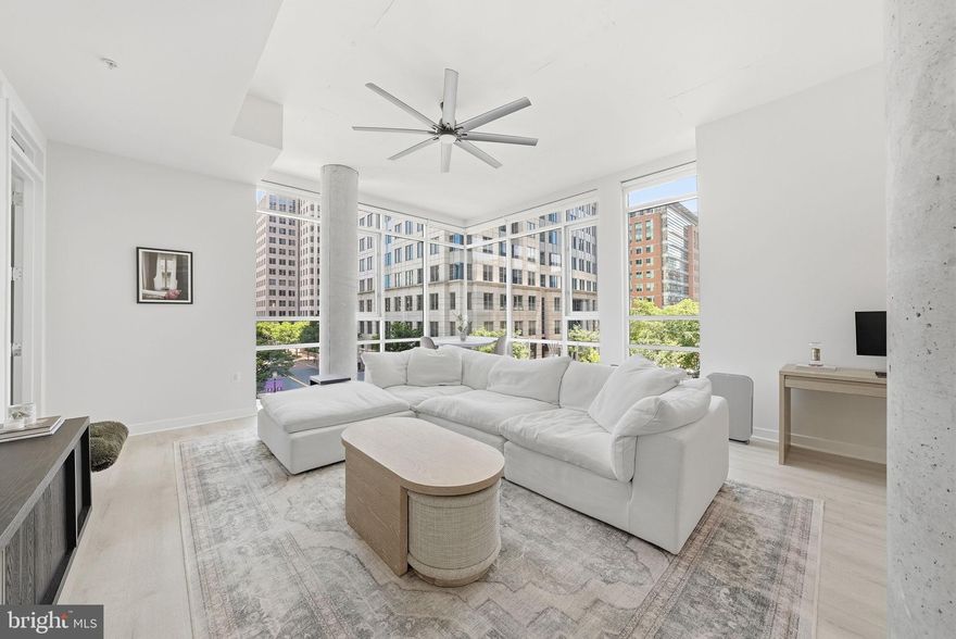 Welcome to Midtown North, situated at the center of everything Reston Town Center has to offer. Restaurants, shops, entertainment, and the Silver Line metro, are all steps from your front door. An extraordinary living experience begins the moment you step inside unit 313. A dramatic entry hallway with a sweeping curved wall and soaring ceilings sets the tone.  Once you turn the corner, the space opens up completely. Walls of windows wrap this corner unit in natural light, creating a bright, airy retreat that feels worlds away from the ordinary. Newly installed LVP floors run through the main living areas and the kitchen is built for real cooking, with a gas range, stainless appliances, and an island that works equally well for a weeknight dinner or a weekend gathering. The dining and living spaces flow naturally together, making the most of every square foot. The primary suite offers a spacious walk-in closet and a well-appointed en-sute bathroom. The second bedroom is well-separated — ideal for guests, a home office, or both. In-unit washer/dryer and two secure underground parking spaces keep the everyday logistics sorted. Building amenities include a fitness center, concierge, and game room. Whether you're commuting into D.C. or working from home, the location delivers and the lifestyle follows.