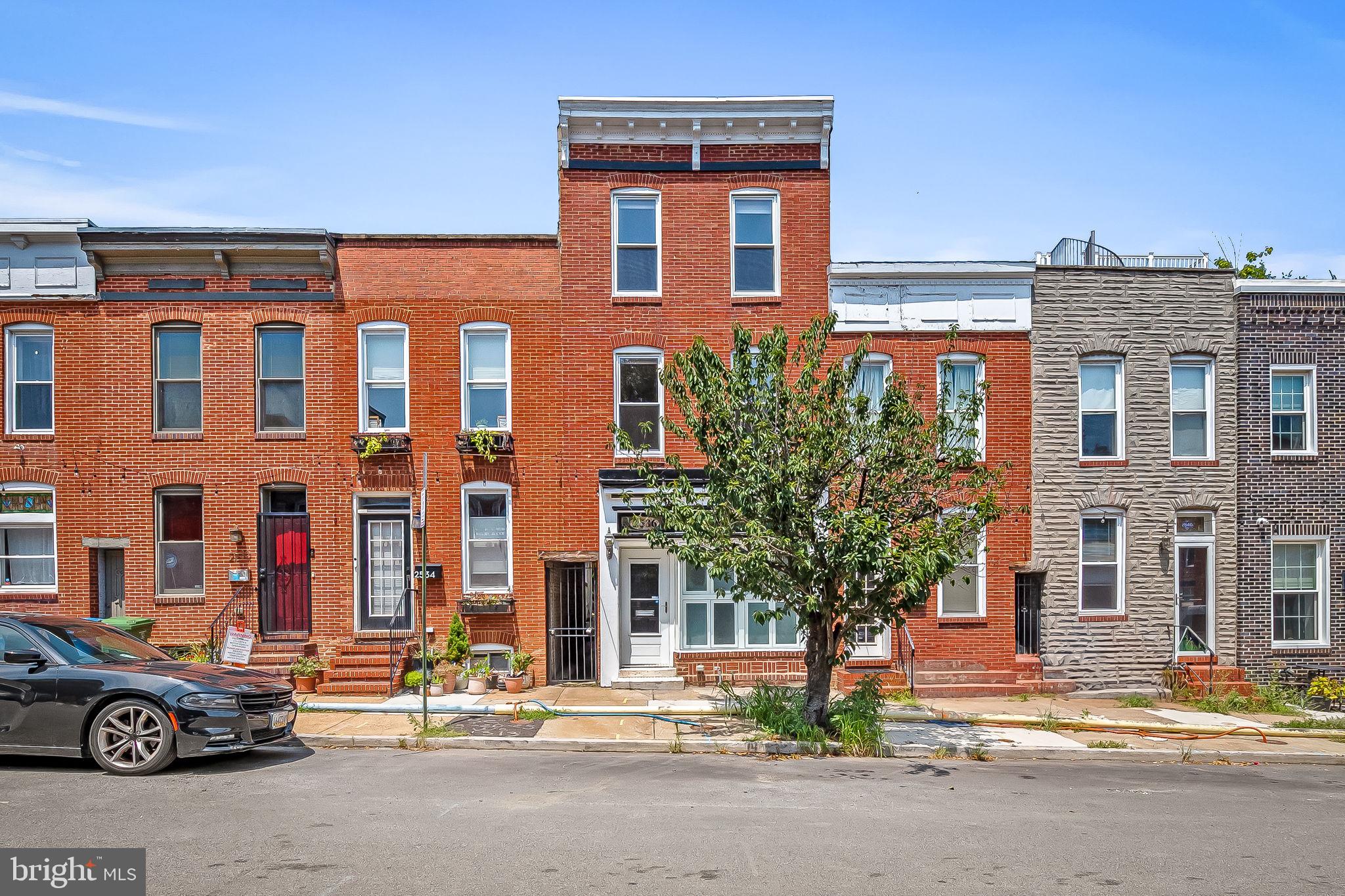 Located in the heart of Canton, this lightly updated and well maintained 2500+ SQFT redbrick townhome features three fully finished levels with 3 bedrooms / 3.5 baths, a rooftop deck, hardwood floors and multiple skylights throughout, a stained glass and bifold window front, and a gourmet kitchen outfitted with a luxury six-burner Wolfe stove/cooktop, stainless steel appliances, and updated Williams Sonoma honeyed cabinets! The second level offers two oversized bedrooms with ensuite bathrooms while the third level boasts a full floor primary suite complete with walk-in closet and walk-in shower with dual showerheads. Main level washer/dryer off the kitchen and additional storage in the 400 SQFT secured cellar. No expense has been spared!