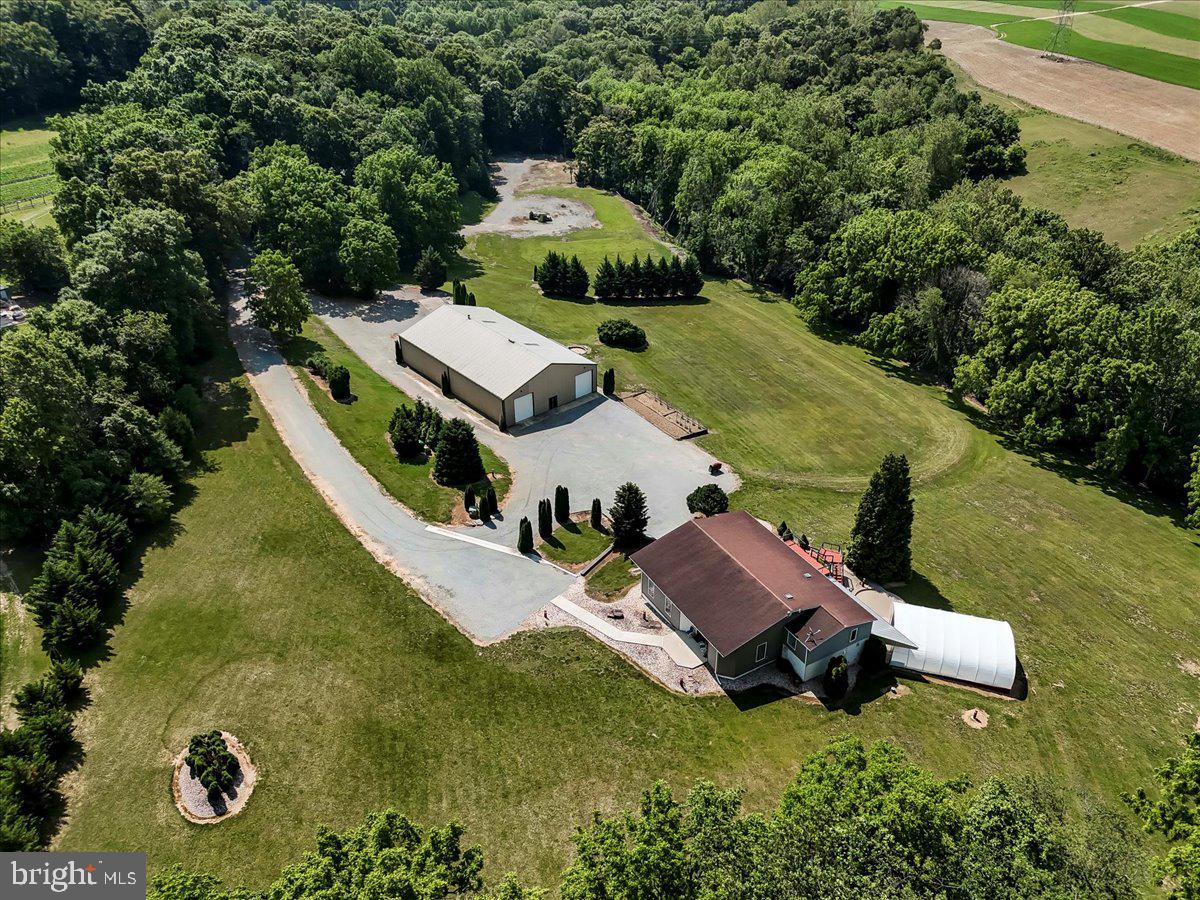 Luxury Living Meets Versatile Workspace on 12.3 Gated Acres
Welcome to 15 Wood Valley Lane—an extraordinary Chester County estate offering the perfect blend of refined living and functional space. Set on 12.3 private, gated acres of scenic countryside, this one-of-a-kind property features a beautifully appointed 4-bedroom, 5-bath main residence, a inground pool and hot tub, and an impressive 60'x100' steel shop with a fully integrated 3-bedroom apartment.
Inside the main home, you'll find expansive, light-filled living areas with tasteful finishes and a warm, inviting atmosphere. The primary suite offers a serene retreat with a luxurious ensuite bath and tranquil views. Each additional bedroom includes its own dedicated bathroom, ideal for family or guests.
Step outside to enjoy the manicured grounds, where a luxurious pool and hot tub area await—perfect for entertaining or relaxing in total privacy.
The massive steel building is a true standout, offering endless potential for business use, hobbies, or storage, and the attached 3-bedroom apartment provides flexibility for multi-generational living, staff quarters, or rental income.
For peace of mind, this property features a hard-wired, whole-house generator.
There’s room here for everything—horses, gardening, equipment, or just breathing room to enjoy the land. Located in a quiet, accessible spot not far from major routes, this property is ideal for someone who wants space to grow, live, and work—all in one place.