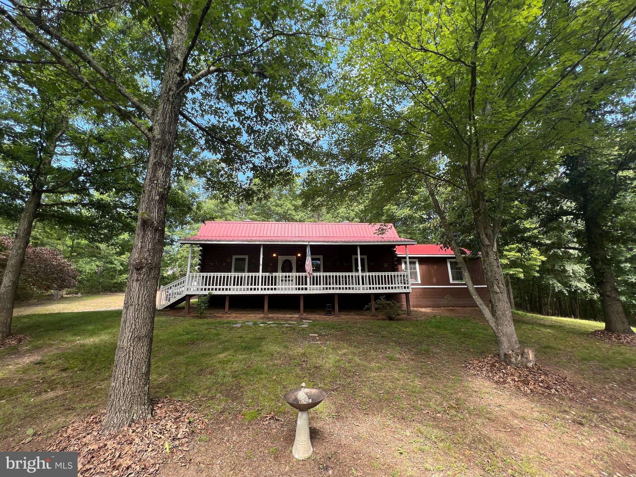 Escape the hustle and bustle of everyday life and retreat to your very own Log Cabin! Located on 141 Dry Run Lane in Berkeley Springs. This 4 bedroom and 2 bathroom 1,827 square foot home is the perfect getaway. Enjoy an open floor plan, spacious living area, and beautiful wooden cabinets and countertops . The kitchen and dining room are finished with true hardwood floors. The main floor bathroom has tile floors and a Clawfoot bathtub. Cozy up by the pellet stove in the living room or Step outside to your large front porch and take in your nice front yard and wooded areas. Located minutes from I-70 and Berkeley Springs. The sellers are also offering a $3,000 seller's credit for the floors in the Bedrooms. Motivated sellers, all reasonable offers will be considered.