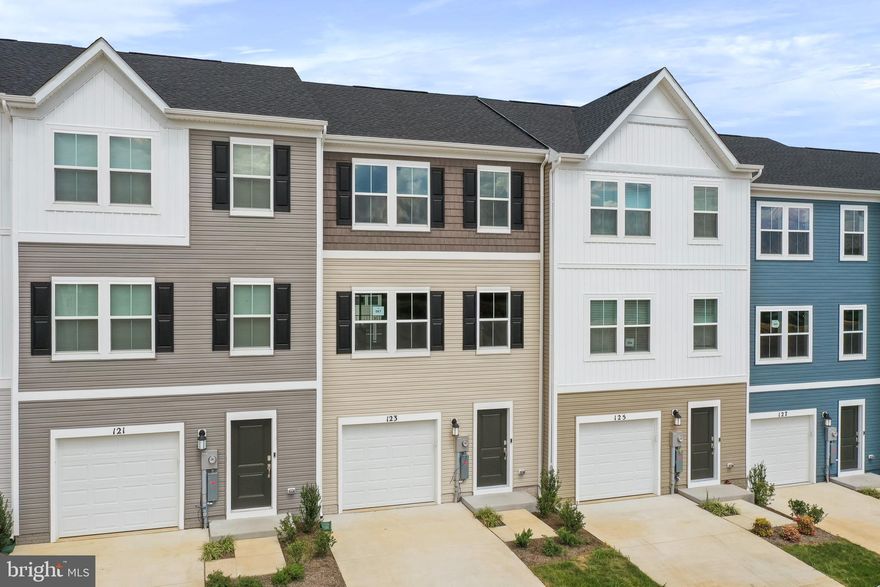 Welcome to The Gallery, one of Martinsburg’s newest communities! Conveniently located near shopping, dining, recreation, and just minutes from I-81, this beautiful end-unit townhome offers added privacy, extra natural light, and enhanced curb appeal.

Enter on the lower level where you’ll find a spacious recreation room — perfect for a home office, gym, or additional living space — along with access to the one-car garage and backyard.

The main level features an open-concept layout with a bright great room flowing into the dining area and kitchen. The kitchen includes stainless steel appliances and ample cabinet space. A convenient half bath is also located on this level, ideal for guests.

Upstairs on the upper level, you’ll find all three bedrooms, two full bathrooms, and the laundry area for added convenience. The primary suite offers a private full bath and generous closet space. Bedrooms two and three are well-sized and share a full hallway bathroom, making this level both functional and comfortable for everyday living.

✨ End units in this desirable community are in high demand — submit your application today and secure this beautiful home before it’s gone!