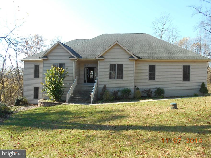 Tons of privacy and potential in this contemporary rancher on 5+ acres. Open floor plan, woodburning fireplace with insert with stunning stacked stone chimney. Granite in kitchen. Master suite w/walk in closets jetted tub & sep shower. Amazing views from 2 covered balconies. Finish the lower level (rough in in place) and have over 5,000 sq ft. Huge unfinished bonus room above garage.  A Steal!