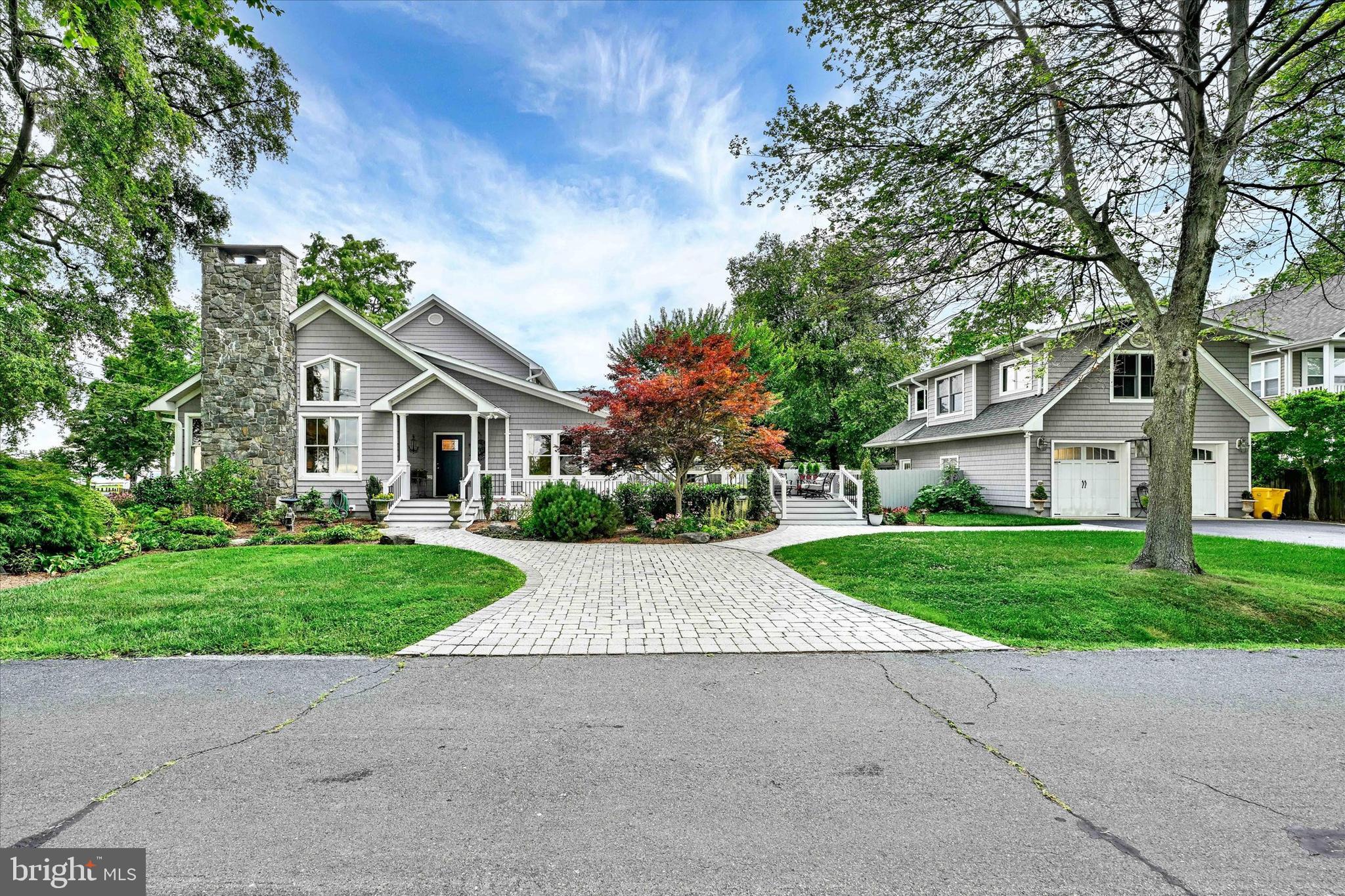 Welcome home to this gorgeous and exceptionally updated and expanded waterfront home. Two primary suites, one on each level, are both designed for relaxation and comfort. There is a fully updated apartment over the detached garage offering guests or family members their own private place to relax and unwind. Breathtaking views will captivate even the most discriminating buyer. Spectacular chef’s kitchen has a 6-burner gas range, Café Frenchdoor wall oven, and a large side by side refrigerator/freezer. Double islands, with quartzite countertops, offer exceptional prep and dining opportunities. The great room has vaulted ceilings and a gas fireplace for added enjoyment. Sip your morning coffee and watch the sunrise in the delightful sunroom. Mature landscaping, spacious deck with pizza oven, and a privacy fence offers an oasis for unwinding after a long day. Be sure to check out the community dock and playground nearby. Please see disclosures for a full list of updates and enhancements.