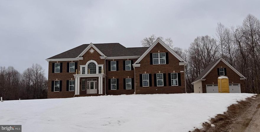 Stunning QBHI Brick front Westminster located on a gorgeous 1 acre lot with surrounding 20+ acres of Open space that conveys with the home. Enter this beautiful home and be Wowed immediately by the grand staircase and gorgeous hardwood flooring.  Features include formal dining room, 2nd suite with large bathroom including QBHI's signature deluxe shower, soak in tub, double vanities and walk in closet.  2 story Family room with coffered ceiling and gas fireplace.  Grand kitchen with large Island, GE appliances, double oven, kitchen table space and large sunroom.  The upper level has a HUGE owners suite with sitting room, an on suite bath with deluxe shower, pedestal tub, separate vanities and custom closet. Bedroom 2 has it's own on suite bathroom and bedrooms 3 and 4 share a bathroom with another deluxe shower and double vanities!  The lower level basement is perfect for a night in or entertaining with a large recreation room, media room, bedroom, bathroom and wet bar.  The areaway leads to the large backyard that is perfect for relaxing outside and future plans. Call to build your home today!