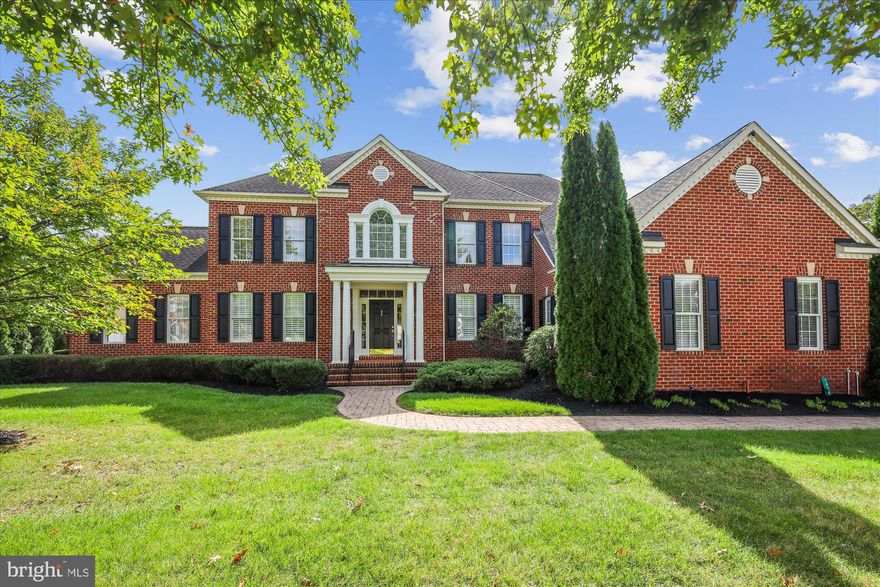 Experience classic architecture and modern livability in this 6,500+ sq ft Koch-built Colonial in the desirable Colonial Manor community. Bright, open interiors, high ceilings, and beautifully landscaped outdoor spaces make this home ideal for both everyday comfort and elegant entertaining.

A rare opportunity – this property features an ASSUMABLE LOAN at just 2.65% interest!! In light of today’s interest rates, this financing option makes this home especially appealing and affordable.

Car enthusiasts will love the attached three-car garage – oversized, with soaring ceilings high enough to accommodate a car lift, abundant storage capacity, and space that could serve as a small workshop if one parking bay is repurposed. It’s a true standout among homes in the neighborhood.

The main level offers a grand two-story foyer with Waterford lighting, a private office, formal living and dining rooms, a light-filled sunroom, and a spacious kitchen with center island, stainless appliances, and casual dining area open to the large family room with a wood-burning fireplace. The laundry and powder room are conveniently located near the garage entry.
Upstairs, the expansive primary suite feels like a retreat, with a sitting room, dual walk-in closets, and a spa-style bath offering an oversized soaking tub, double vanity, and separate shower. Four additional generously sized bedrooms share Jack-and-Jill baths, providing each with direct access to a full bathroom.

The finished lower level – nearly 2,000 sq ft – includes a potential sixth bedroom (currently used as an entertainment room) and a full bath with multi-head shower. The expansive open area offers endless possibilities for recreation, media, or fitness, and already includes rough-in plumbing for a future full wet bar. Two large unfinished areas provide excellent utility and storage options, along with additional storage beneath the central staircase. With walk-out access to the rear patio, this level is ready to be customized into the ultimate entertaining or multi-purpose space.

Freshly painted inside and out within the past three years, the home also includes updated lighting, new shutters and window treatments, plantation shutters through the main level, newer washer, dryer, dishwasher, and a water softener.  Seller offering a one year home warranty.

Set on a beautifully landscaped lot with a two-tiered entertaining patio and in-ground irrigation, this residence combines space, craftsmanship, and location – just minutes to Downtown Annapolis, Broadneck schools, Route 50, and BWI.