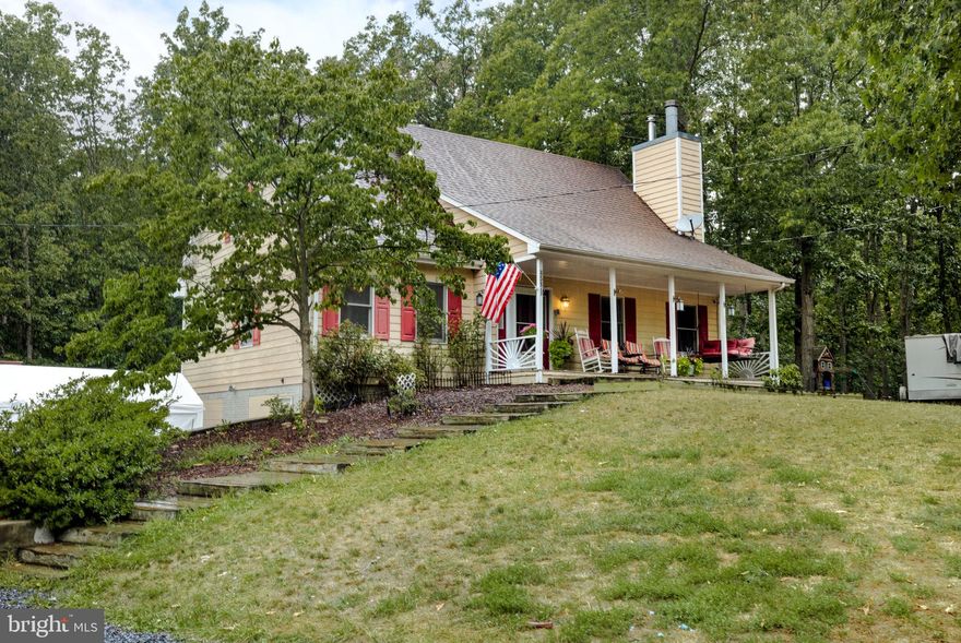 Beautiful Private home surrounded by trees.  3+ acre lot backs up to Sherando Park.  A beautiful large front porch welcomes you into this 3 level Cape Cod style home. Inside are  New Carpets and Fresh Paint with Neutral Grey colors.  The 2-story foyer welcomes you in with wood stairs leading up to the 2nd level.  Kitchen offers newer SS range. Huge Pantry cabinet with pull out shelves and multiple drawers for easy organizing.  Dining area in the kitchen.  Off the kitchen is the laundry closet with newish  front loading washer/dryer right on the main level. The main level living room offers a ceiling fan, new carpet, and hours of relaxation next to the wood burning fireplace. Main level owners’ suite has white paint ceiling fan and attached Primary full bath. Primary Bath has large soaking tub, separate shower and a walk-in closet.  Main Level has a 3-season room directly off the dining area that offers space to enjoy nature and the beautiful trees.
Upstairs there are two large bedrooms both with walk in closets, ceiling fans, window A/C units and loads of storage in the cape cod style floored attic spaces attached to each bedroom. 
The lower level has been partially finished, freshly painted and brand-new carpeting in the family room and plenty of unfinished storage space. 
The oversized garage is 16 Ft high, 20 x 50 Ft in the main area and kick out offering another 16 x 18 Ft.  It was once used to maintain large trucks, has plenty of space for 2 cars, truck, small boat, whatever you like to ride.  The garage has an oil heater, and an air compressor that are working but will convey in as is condition.   There are 2 storage sheds and a dog run also on this property that will convey in as is condition.  
Sherando Highschool within walking distance. 
Sherando Park (Locally known as The Jewel of the Blue Ridge Mountain Area) is located right next door to this 3.06-acre lot. Just walk through the gate to get to Sherando Park.  The Park has hiking trails, and a lake for swimming, fishing, picnicking, and enjoying the outdoors. This beautiful home is conveniently located within a 5-minute drive of I- 81. Stephens City stores, shops, restaurants are nearby, and Winchester Amenities are within a 15–20-minute drive. This home is easy to commute to plus offers unique privacy!