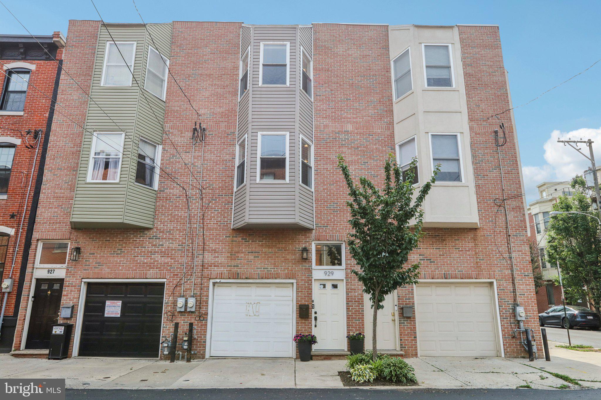 Welcome to your Graduate Hospital retreat—an updated, move-in ready 3-bedroom, 3-bath townhouse offering over 2,100 square feet of stylish living, a 1-car garage, and two exceptional outdoor spaces. Enter through your private garage and head up to the bright and airy main level, where a spacious open-concept living and dining area is bathed in natural light from oversized bay windows. The adjacent kitchen is thoughtfully designed with white cabinetry, ample storage, a decorative tile backsplash, and a convenient coffee bar with tons of smart storage. Enjoy your morning cup on the charming deck just off the kitchen.
Upstairs, you'll find two generously sized bedrooms, both with ensuite bathrooms featuring modern finishes and a neutral palette. The primary suite includes charming built-in window storage, adding both character and practical functionality. A full-size laundry area completes this level for added convenience.
The first floor offers flexible living with a third bedroom or den—complete with a full ensuite bath and access to your private patio and green space, perfect for relaxing after a long day.
A finished basement, accessible through the garage, is currently used as a gym but offers endless possibilities as a playroom, entertainment zone, or home office. Perfectly situated in one of Philadelphia’s most desirable neighborhoods, this home blends comfort, space, and city living at its finest.
