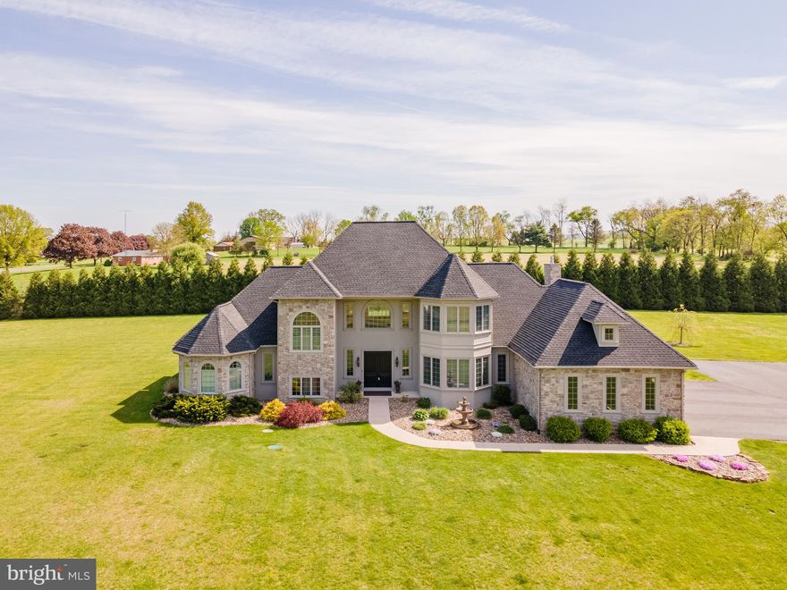 Stunning Quality Custom Build!   This lovely home boost over 5,000 sq ft of well appointed living space.   Located on 7.5 acres, complete with a view of the Conococheague.  The double door entry welcomes you into a spacious foyer that extends to the living room with 2 story vaulted ceiling which opens to the 2nd floor hallway. Brazilian cherry floors lead the path through out the home.  Adjacent,  separate dining room is sure to host the best of gatherings.  Oversized gourmet kitchen with granite counters,  stainless appliances, gas cooktop and walk-in pantry are sure to please.  Breakfast bar adds additional work space and hosts the beverage refrigerator and prep sink.   Cozy family room with gas fireplace , inviting sunroom, complete this well thought out open floor plan area.  1/2 bath and conveniently located, spacious laundry room are off the kitchen and garage access.  The well light home office with French doors provides the perfect quiet "homeschool or working from home" environment.   Tucked back the 1st floor hallway is the grand primary suite.  1st floor primary bedroom has dual walk- in closets, tray ceiling and exit to the rear patio.  Primary bath offers a two person whirlpool tub, water closet, walk-in ceramic tile shower, granite countertops with dual sinks and large linen closet.  Recessed lighting , surround sound and great natural light beams through the home.   2nd floor offers a 2nd primary bedroom with en  suite bath and walk-in closet.  2 additional bedrooms with walk-ins closets and a full bath round out the 2nd floor.  Full, pour walls/unfinished basement with dual staircases (one leading to the garage, other off the foyer) is the perfect area to expand.  Attached oversized 3 car garage.    Dual heat pumps.  Detached, 2 level 30x40 storage/workshop barn to house mowers and other outdoor equipment, etc. complete this spectacular property.