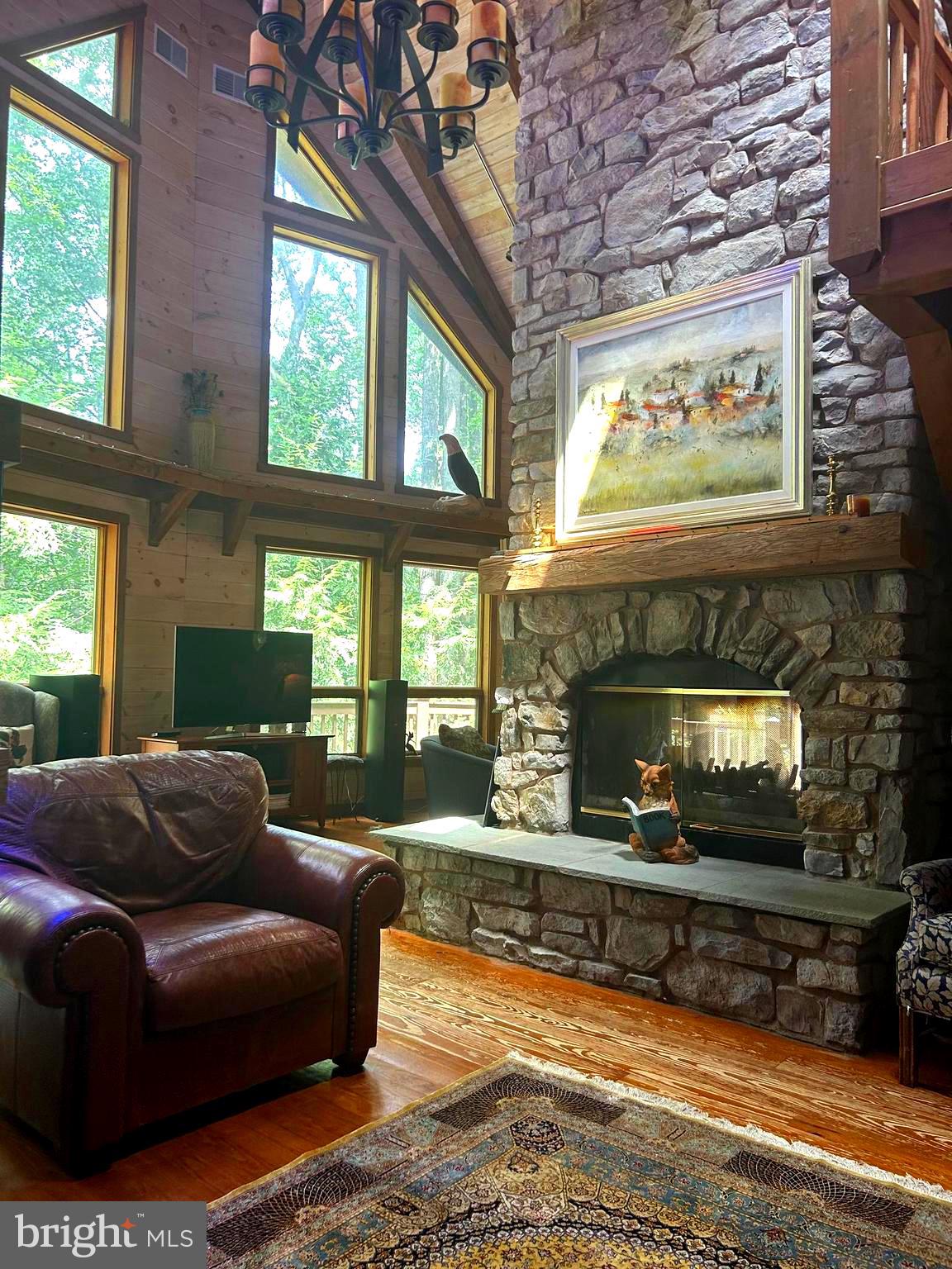 OPEN HOUSE SATURDAY SEPTEMBER 13, 11-2 pm.
Welcome to Spring Hill Acres a Private A-Frame Retreat on Over 8 Wooded Acres.
Plenty of possibilities with this home. Own as a second home and can be used as a short/long term rental.
Tucked away in the heart of Spring Hill Acres, this stunning A-Frame log cabin-style home offers unmatched privacy, charm, and space on over 8 acres of mature woodland and beautifully landscaped land.
Featuring 4 bedrooms, 3 full baths and a flexible floor plan, this home is ideal for those seeking both comfort and connection to nature.
Enjoy first-floor living with an open-concept design showcasing a gourmet kitchen, large dining area, and a stunning double-sided stone fireplace in the living room. French doors open to a wraparound porch, perfect for entertaining or quiet mornings in the fresh air. The owner's suite includes private deck access, a walk-in closet, and a spa-like bath with roll-in shower and double vanity.
Upstairs features a loft, three large bedrooms, and a full bath with skylight. A separate stairway from the bonus room over the garage offers additional privacy--great for guests or multigenerational living.
The finished lower level boasts a family room with wood-burning stove, walk-out access, a wet bar, and a wine cellar. Enjoy a 4-season sunroom for a year-round birdwatching, a 3-car garage, and thoughtful upgrades like a geothermal HVAC system, automatic generator, and security driveway sensors.
Outside, explore landscaped gardens, a fenced 2-acre pet area, a rose garden, and a tranquil fishpond with a waterfall and stone path. The newly paved driveway includes sensor lighting and mid-way parking pad. This peaceful, well-appointed home blends rustic elegance with modern convenience. Don't miss your chance to tour this private paradise!