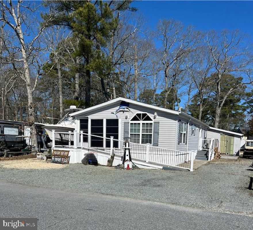Welcome to this Skyline Manufactured Home. This beautiful spacious 3 bedroom 2 full bath double wide beach home in a marina community has much to offer, and is only seconds away from the bay and the docks. The marina leads out to Rehoboth Bay with access to the ocean. Pebbles surround this home for an easy maintenance beach get away. The house has an alley behind it to help move boats/toys in and off of lot with a outdoor storage box and a built on shed. Each bedroom is a nice size with full size closets. The kitchen is huge with plenty of storage space, an island, and vaulted ceilings. Off the kitchen on one side is a generous size laundry room/utility room. On the other end of the kitchen is a full sun room with a dining room table with sliding glass doors to the screened in porch. The master bathroom has a huge shower.There is a 10x14 screened in front porch, 10x12 shed with ramp. The pool is located directly down the street over looking the bay. Boat docks are available to rent. HOA is voluntary. 1 hour notice is required. House is NOT furnished. Must apply for park approval. Lot rent is $10380 Per Year with a renewable lease yearly. If paid in full yearly there is a 400.00 discount. The extra 30.00 is a state relocation trust fund. Closing costs include a 3.75% DMV Document and Settlement Fee which will be split 50/50. Bring ALL OFFERS!!!