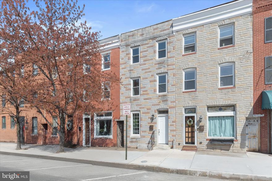 Stunningly renovated stone interior townhome in the heart of Canton! This beautifully updated residence blends timeless character with modern sophistication across every level. Step into the main level and be welcomed by marble-inspired ceramic flooring, elegant classic columns, chair railing, box wainscoting, and crown molding that define the spacious living and dining areas.  At the center of the home, the gourmet kitchen impresses with 42” cabinetry featuring soft-close drawers, quartz countertops, a sleek glass tile backsplash, and stainless steel appliances, perfectly positioned for seamless indoor-outdoor living with direct access to the rear patio. A stylish powder room with eye-catching geometric tile completes the main level.  Retreat to the penthouse primary suite, filled with natural light and offering hardwood floors, a walk-in closet with a custom organization system, and a luxurious en-suite bath showcasing modern finishes and fixtures. Two additional bedrooms, each with hardwood flooring, generous closet space, and their own en-suite baths, provide comfort and privacy for family or guests.  Ideally located just moments from Canton’s vibrant dining, shopping, and entertainment, including O’Donnell Square, Canton Crossing, and the Inner Harbor. Commuters will appreciate easy access to major routes, including I-83, I-695, and I-95. This turnkey home delivers the perfect combination of style, convenience, and location.