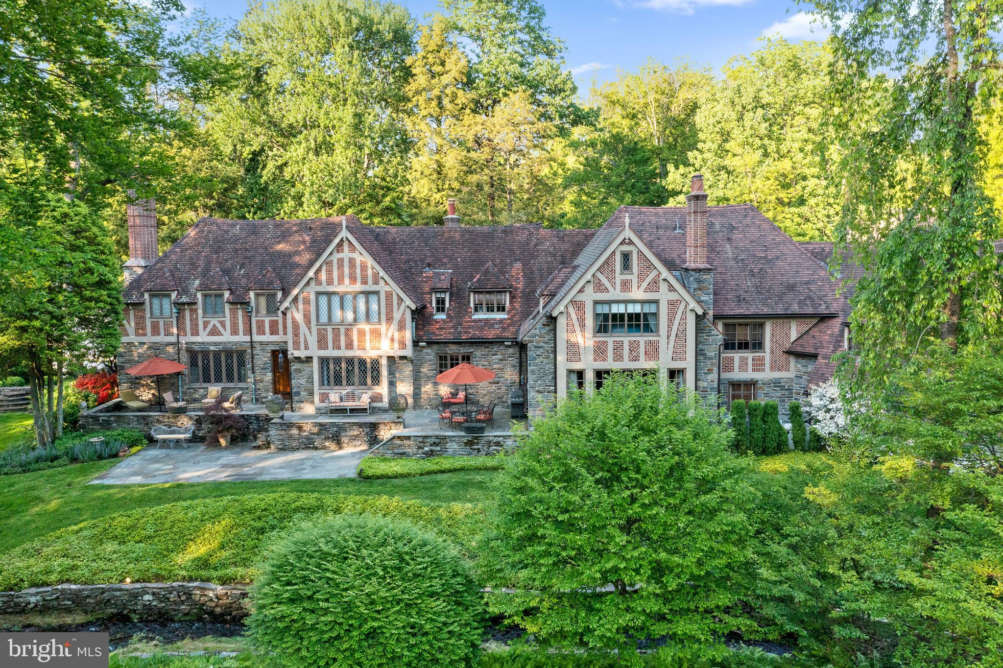 This impeccably renovated and maintained estate home sits on a beautiful, quiet, sought after cul-de-sac street. This is truly a coveted prime Northside Lower Merion location making this home incomparable in every way. The original home was built in the Tudor Style circa 1935 by Frank Wilson, a prominent Main Line Builder known for his expertise in structural engineering, truly the glory days of home building. This home features fine craftsmanship, attention to detail, superior materials, exceptional scale, millwork and stonework very rarely seen in contemporary building trades. Peter Zimmerman Architects worked closely with the owners to renovate and substantially expand this home to accommodate a growing family while enhancing the past glory of this beautiful home. A delightful stream meanders across the front of the property, and the siting of this home allows for truly lovely views of the steam and the expansive grounds from many of the rooms. A long private drive brings you to an impressive entrance courtyard where you will notice that the addition in this section and courtyard were angled away from the main house to follow the path of the stream and create and expansive approach. The owner worked very closely with the architect to ensure preservation of the original details and integrate award winning details, materials, proportions and layout so finely that only a well-trained architectural historian can tell them apart. The clay roof tiles were custom made by Ludowici, the same company that manufactured the original tiles, to ensure a perfect match. The original steel windows were restored, and new ones were reproduced to match, while the extraordinary decorative brickwork and stonework, half timbering, wood and stone details inside and out make it nearly impossible to find the intersection between the original and new construction. The transition on the inside and out is seamless. Beech Road, Bryn Mawr is a truly coveted location enjoying a very quiet cul-de-sac but extremely convenient to Philadelphia, King of Prussia, Rt. 76, Rt. 476 and beyond. It is a very quick walk to Ashbridge Park for family play time, tennis or a workout, as well as a very easy walk to the train station. A leisurely stroll into Bryn Mawr allows you to enjoy the Film Institute, fantastic dinner options, shopping, the Bryn Mawr Farmers Market, Ludington Library, Mom’s Market and yet return to your private oasis within minutes. This property offers a rare ownership opportunity in Bryn Mawr offering privacy but easy access to all the attractions, conveniences, and beauty of the Main Line. As you can see from these photos this home is glorious in any season!