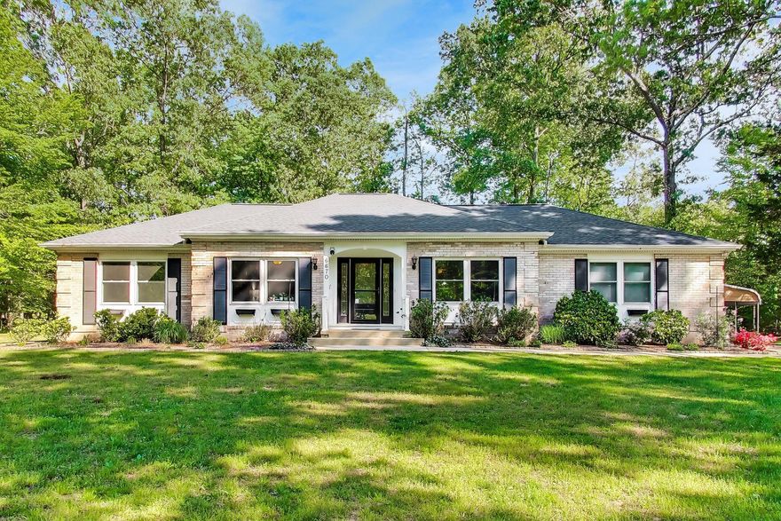 Updated all-brick rambler on nearly 1 acre! This 3BR, 2BA home offers an open layout with a spacious living/dining area featuring a brick wood-burning/gas fireplace. Kitchen includes 42” cabinets, stainless steel appliances, smooth-top range, convection oven, under-cabinet lighting, dual sink & breakfast bar, and open to the main living space. Bright sunroom overlooks a private, partially wooded rear yard. Flexible room with chair railing, currently used as a 4th bedroom (ideal for an office/den or formal dining room). Primary suite includes a walk-in closet & an updated ensuite bath. Both bathrooms have been recently renovated.  Laundry/mudroom off kitchen leads to side-load 2-car garage and access to rear yard. Exterior features new vinyl fencing w/ 3 gates, patio, large shed & additional 2+ car carport. Home sits well off the street for added privacy. Upgrades include hardwood floors, ceramic tile, ceiling fans throughout, a new 25-year roof & Andersen Low-E sunroom windows (transferable warranties), double-hung windows & gutter guards. Heat pump w/ oil backup. Convenient to schools, shopping & parks—peaceful setting!
