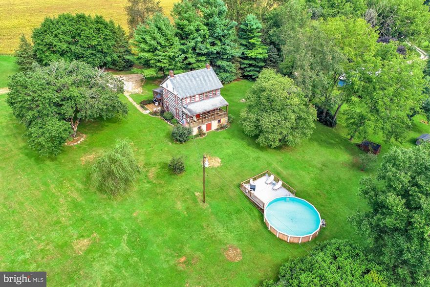 This restored log home has privacy at its best.  The 10 acre farmette sits at the end of the road with great views of farmland all around.  The exterior has been restored exposing the logs, plus the interior has been restored also showing the logs.  Updated bath, kitchen was updated a few years ago.  Home has a walk-in closet off the main bedroom plus one off the full bath.  Sit on the front porch that overlooks the above ground pool and the private acreage.  The side deck also offers great privacy and views.  A detached office/workshop has electric and internet pre-wired, it is also built as a security building if needed.  This is a must see property to appreciate the restoration and privacy.