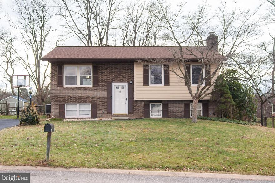 **SHOWINGS BEGIN FRIDAY 1/5** This 4 bedroom, 2 full bath, 1800 square foot home is move-in ready! Situated in the desirable Carrolltowne neighborhood, it has been freshly painted and has plenty of updates!  Kitchen appliances, granite counters, flooring & sink were all redone in 2018! New roof, gutters, downspouts, and deck in 2017. The heat pump & compressor were replaced in 2014. Newer hall bath with ceramic tub surround & flooring.  Other updates include new toilets, a new concrete base for the shed, and a driveway resurfacing in 2021. A large finished lower level that is perfect for gathering for the big game, or just letting the kids have their own space. The wood-burning fireplace makes this room extra cozy! There is a true bedroom on this level with a recently redone full bath. The walk-out leads to the fully fenced rear yard.  The backyard boasts a brand new 27' pool, professionally installed!  It is a summer oasis! sit on the deck under the sail and watch the kids play. The green space beyond your fence makes for a great vista. Deep within the neighborhood, but with quick access to shopping, dining, and all the major commuter routes!