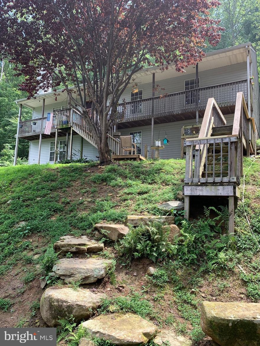 Very well maintained Rambler, Nice kitchen with breakfast bar, French door leading to back deck, Cathedral Ceiling, Fireplace.   Flooring is hardwood, ceramic tile & vinyl. Fully finished walkout basement with possible 4th bedroom, family rm, laundry rm, storage & more. Fully front porch to enjoy the Mountain Views.  Gorgeous Views from the small unfinished building and deck behind & above the home, 4 wheeling trails & frog pond in the woods, circular driveway partly paved. Septic pump replaced in 2018. Also included in the sale is the adjoining lot containing 2.75 Acres, TM: 27A-11-10.