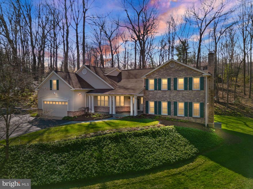 Nestled on a sprawling 3.36-acre property, this meticulously maintained 5-bedroom and 3.5-bath home offers a perfect blend of modern comfort and serene natural surroundings. From its maintenance-free exterior featuring siding and window frames to the thoughtful interior enhancements, every detail has been carefully considered to create a harmonious living space. Additionally, the property boasts a third full garage bay designed as a convenient pull-through, ensuring ample space for a third vehicle without compromising the aesthetic appeal from the front of the house.

Step inside to discover a wealth of features designed to enhance both daily living and entertaining. Hardwood floors create a seamless flow throughout the main living areas including the kitchen, living room, dining room, and four bedrooms. High-speed Ethernet/Cat5 cabling ensures connectivity is never an issue, with multiple lines extending to the office and guest suite, making remote work or entertainment a breeze.

The heart of the home lies in the family room, where an antique fireplace surround and Vermont Castings wood stove exude warmth and character. Bay windows offer enchanting views of the surrounding forest and creek, inviting you to unwind and relax in the comfort of your own space.

For those with creative inclinations, a spacious craft room beckons with its large windows overlooking the woods, providing ample natural light for artistic pursuits. Meanwhile, the first-floor office is primed for productivity, boasting extra electrical circuits and Ethernet/Cat5 lines for seamless internet access.

Entertaining is effortless in the living and dining rooms, where custom built-ins, French doors, and expansive views of the natural landscape set the scene for memorable gatherings. Upstairs, the bedrooms offer not only walk-in closets but also breathtaking vistas of the woods and stream valley, providing a tranquil retreat at the end of the day.

The primary suite is a sanctuary unto itself, featuring a sitting room, multiple closets including a large walk-in, and a fully renovated bathroom completed in 2024. Guests will feel right at home in their private suite, complete with a separate entrance, full bathroom, and a large finished bonus room over the garage.

Practicality meets convenience in the mudroom/laundry room, where built-in cabinetry and custom cubbies streamline organization. Downstairs, the finished basement offers versatile spaces for recreation and storage, with custom built-ins and enhanced electrical wiring for workshop tools. 

Outside, the property is a nature lover's paradise, boasting acres of pristine woodland, terraced backyard, stone walls,  direct access to Little Difficult Run Creek, and backing to Fred Crabtree Park. Whether you're lounging on the screened-in porch, exploring the walking path along the creek, or simply enjoying the views from the decks and patios, this home offers a rare opportunity to embrace the beauty of nature without sacrificing modern amenities.